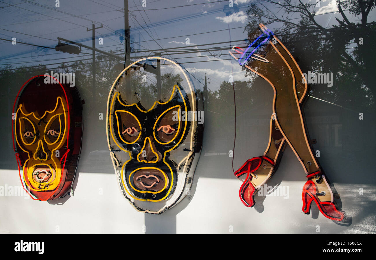 Neon signs of luchadores and legs at the Roadhouse Relics art gallery in Austin, Texas Stock Photo