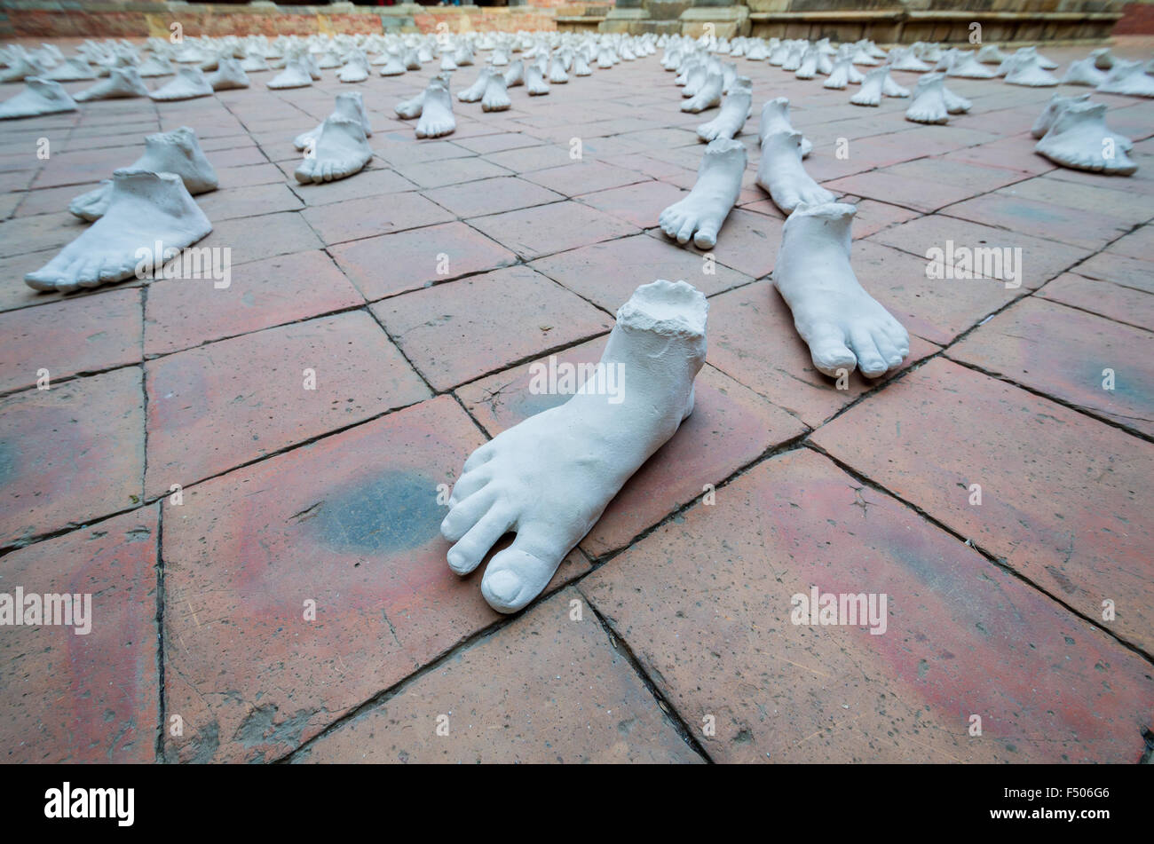 White sculptures of feet arranged as an art exhibition Stock Photo