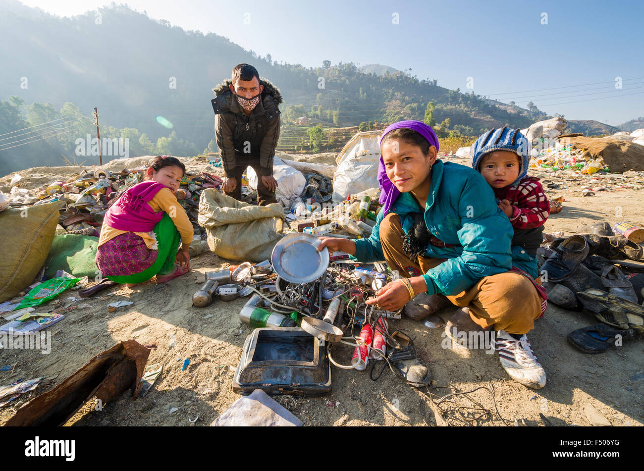 Family with a small child sorting out garbage at Aletar garbage dump Stock Photo