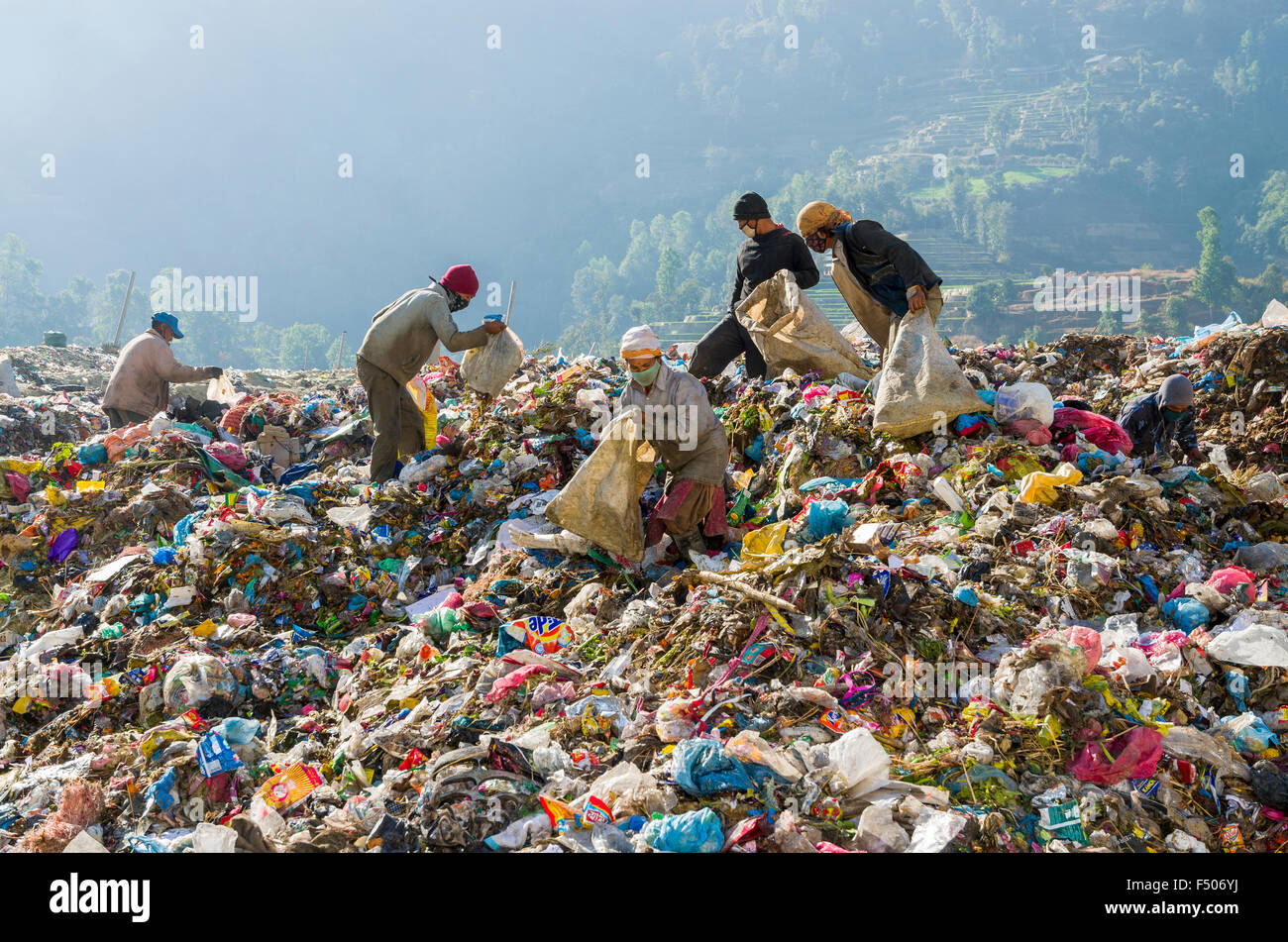 Workers sorting out garbage at Aletar garbage dump, earning 300-400 nepali rupees a day Stock Photo