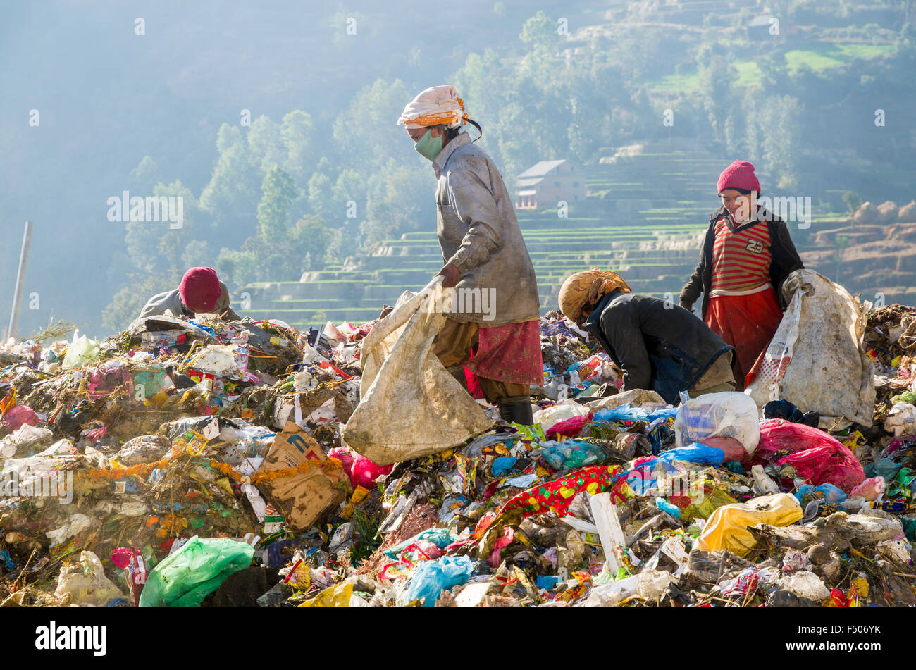 Women sorting out garbage at Aletar garbage dump, earning 300-400 nepali rupees a day Stock Photo