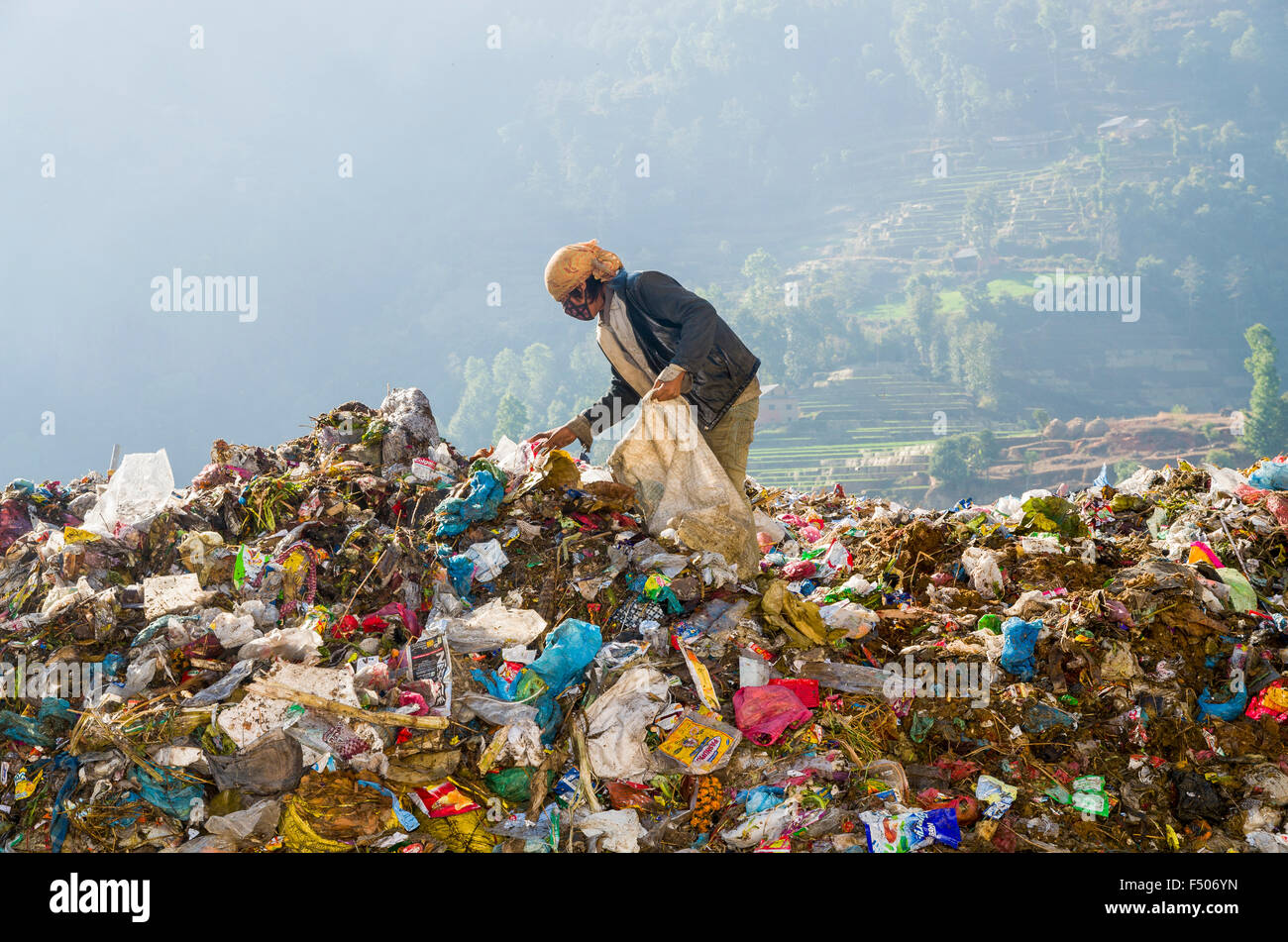 Woman sorting out garbage at Aletar garbage dump, earning 300-400 nepali rupees a day Stock Photo