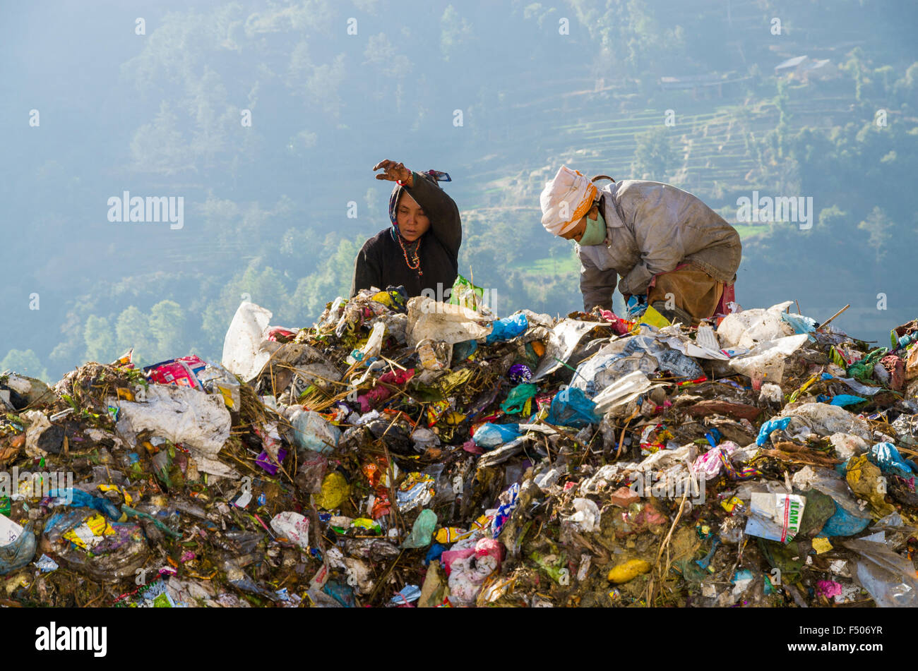 Women sorting out garbage at Aletar garbage dump, earning 300-400 nepali rupees a day Stock Photo