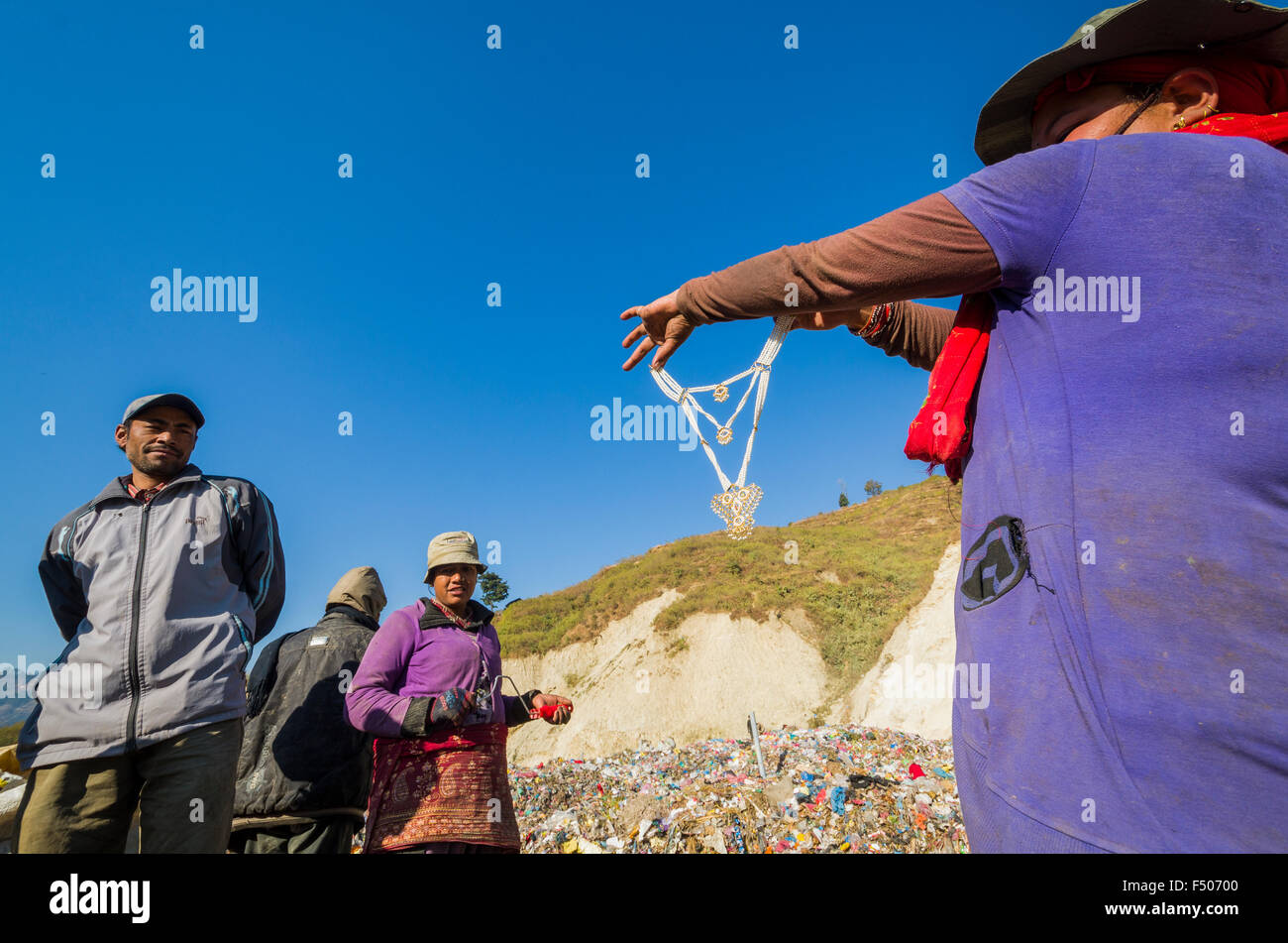 Woman sorting out garbage at Aletar garbage dump, found a piece of cheap jewellery Stock Photo