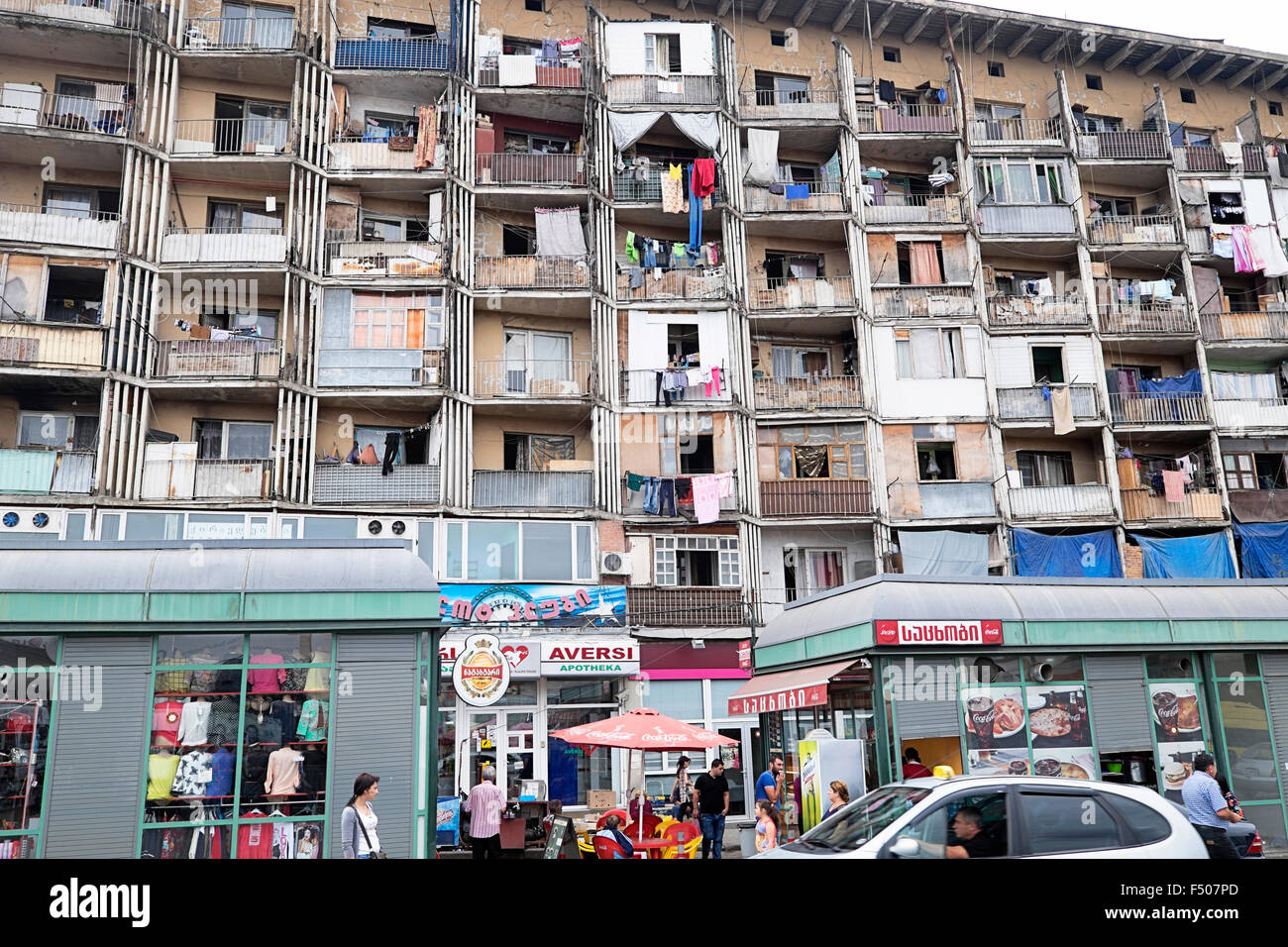 Housing above shops in Central Tbilisi opposite the modern ground where Dinamo Tbilisi play football. Stock Photo