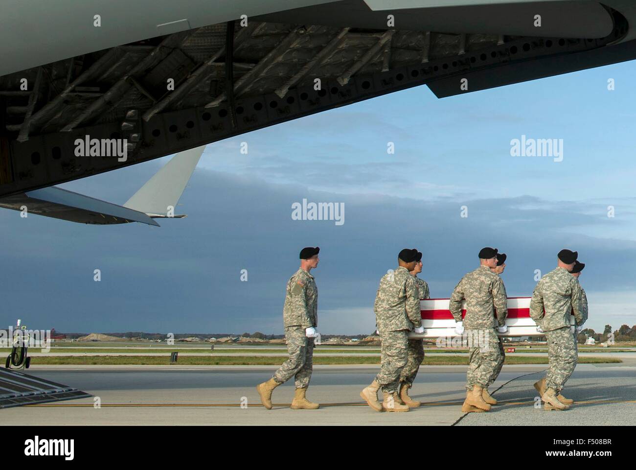 A US Army carry team transfers the remains of U.S. Army Master Sgt. Joshua L. Wheeler killed in action in Iraq during a removal ceremony October 24, 2015 at Dover Air Force Base, Delaware. Secretary of Defense Ash Carter attended the ceremony to pay his respects to the fallen soldier. Stock Photo