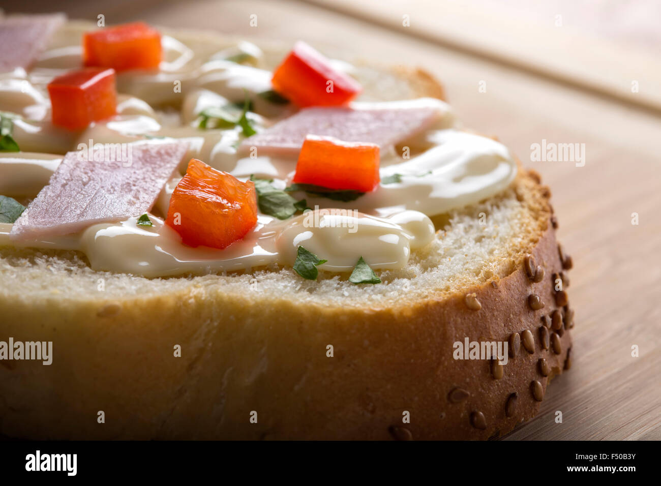 Cream cheese mixed with red pepper and parsley on a slice of bread Stock Photo Alamy
