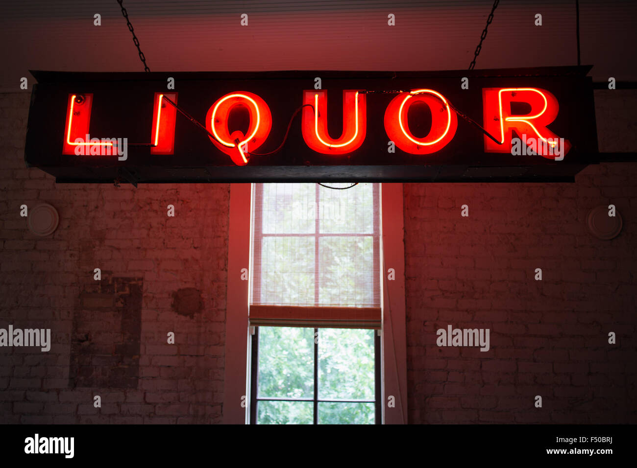 Neon Liquor sign inside of a bar Stock Photo