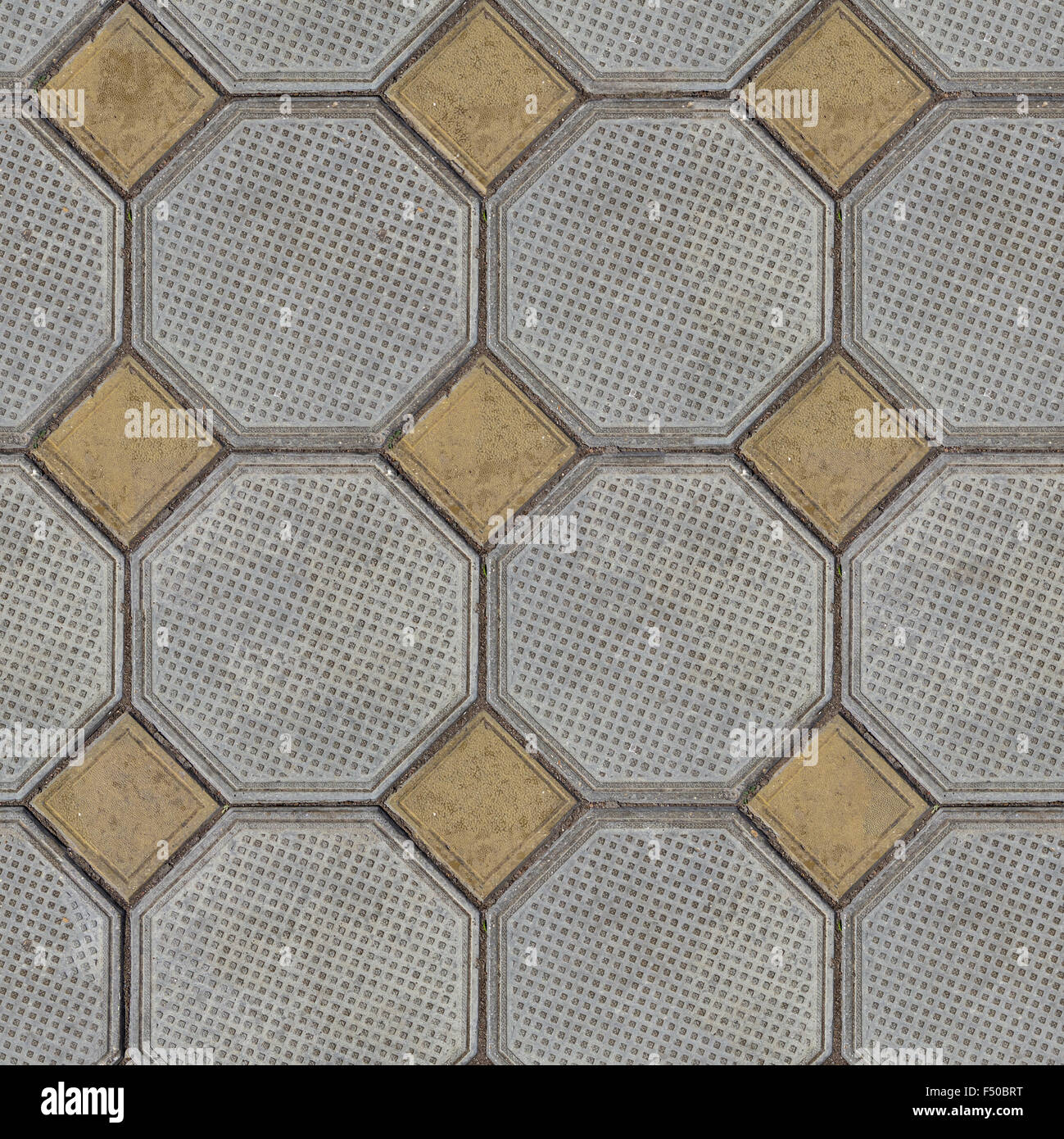Tiles Laid out of Large Gray Polygons and Small Yellow Squares in the Corners. Stock Photo