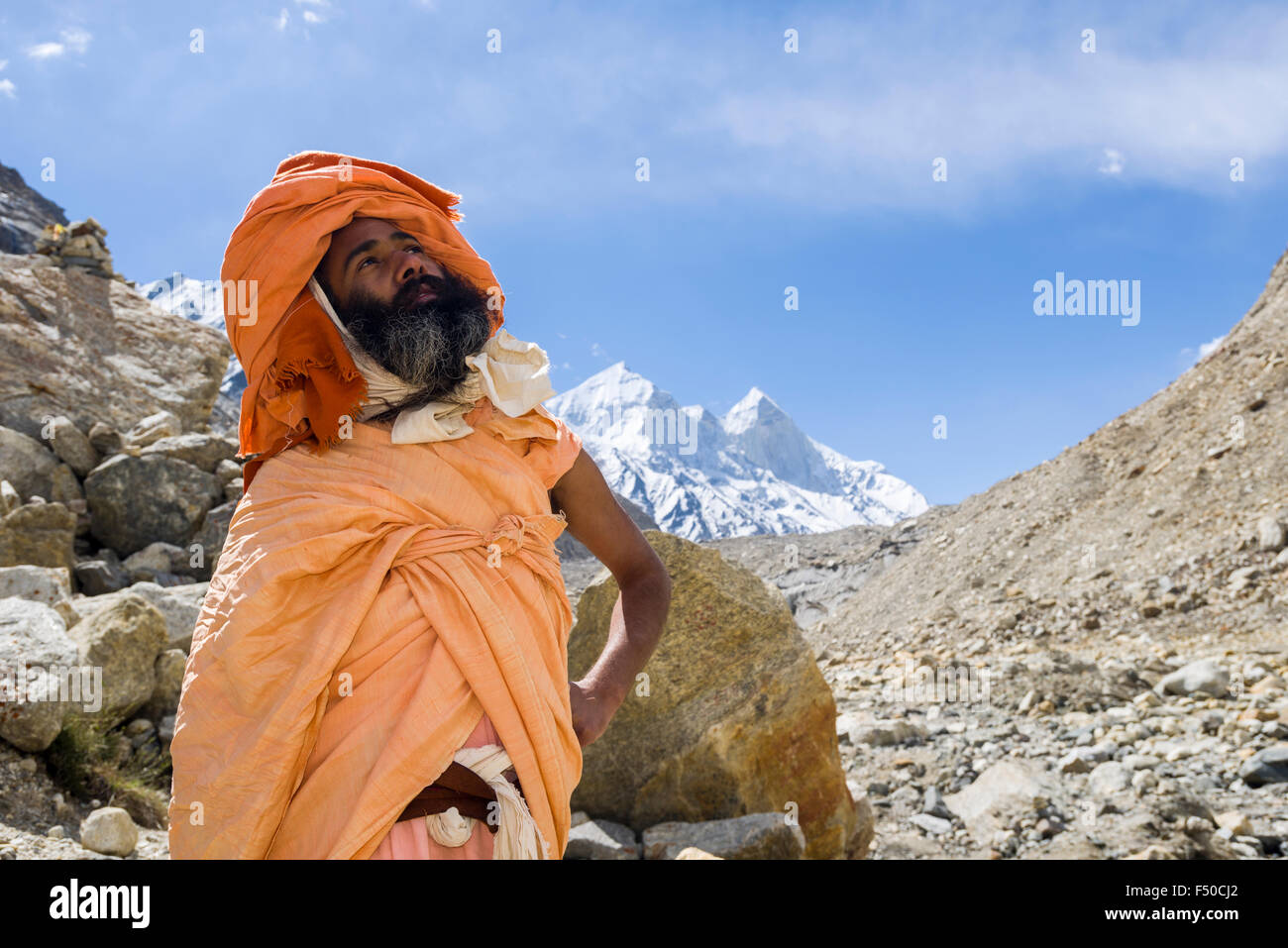 A Sadhu, holy man, is standing and praying at Gaumukh, the main source of the holy river Ganges Stock Photo