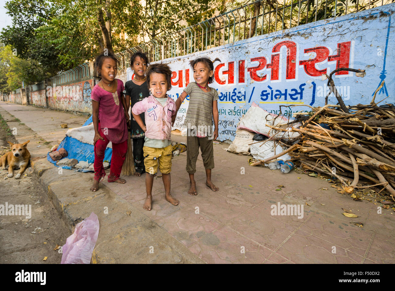 Street kids, children, are living just beside busy roads on the pavement Stock Photo
