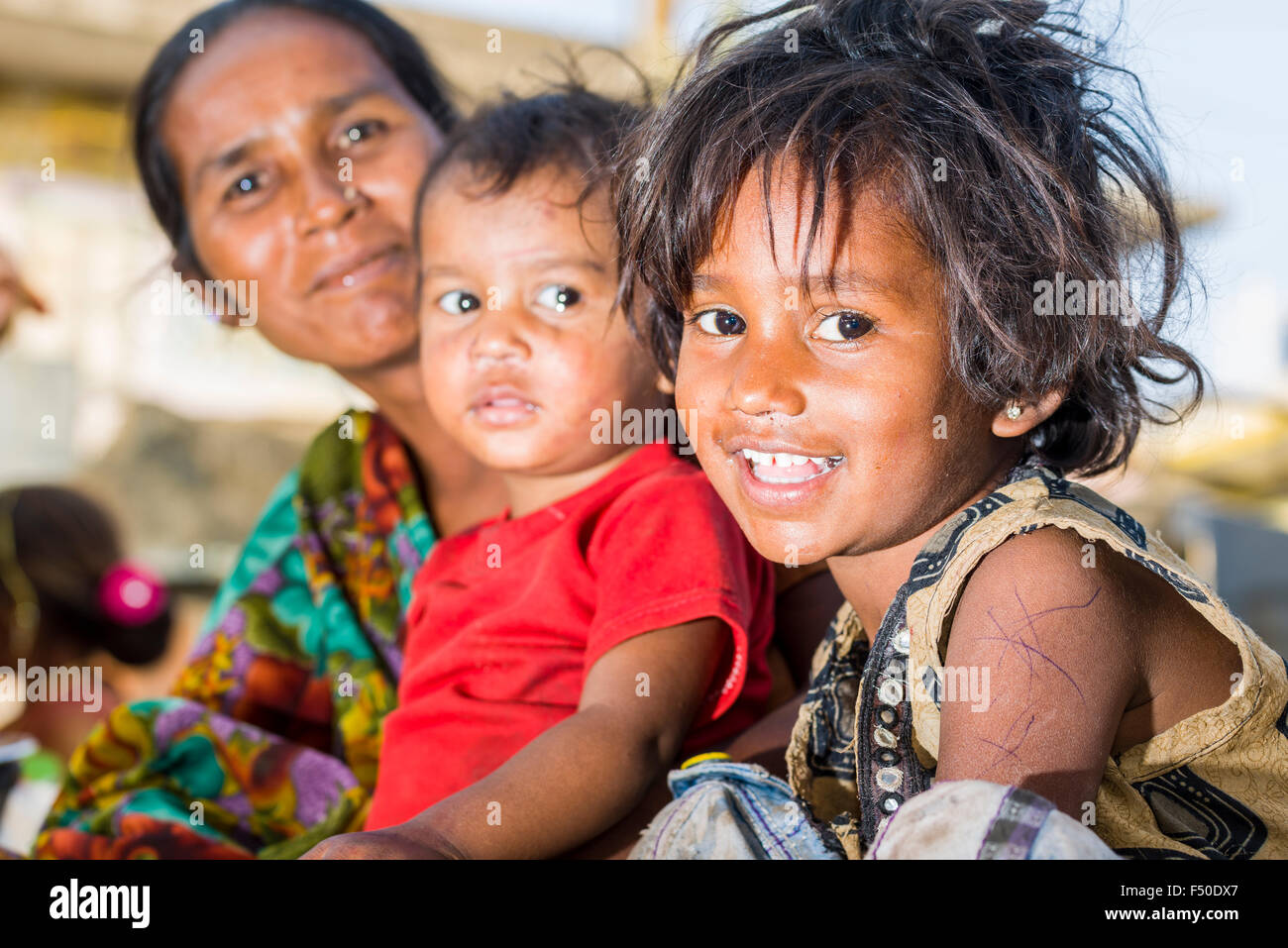 A portrait of two children and a woman, working at a vegetable market Stock Photo
