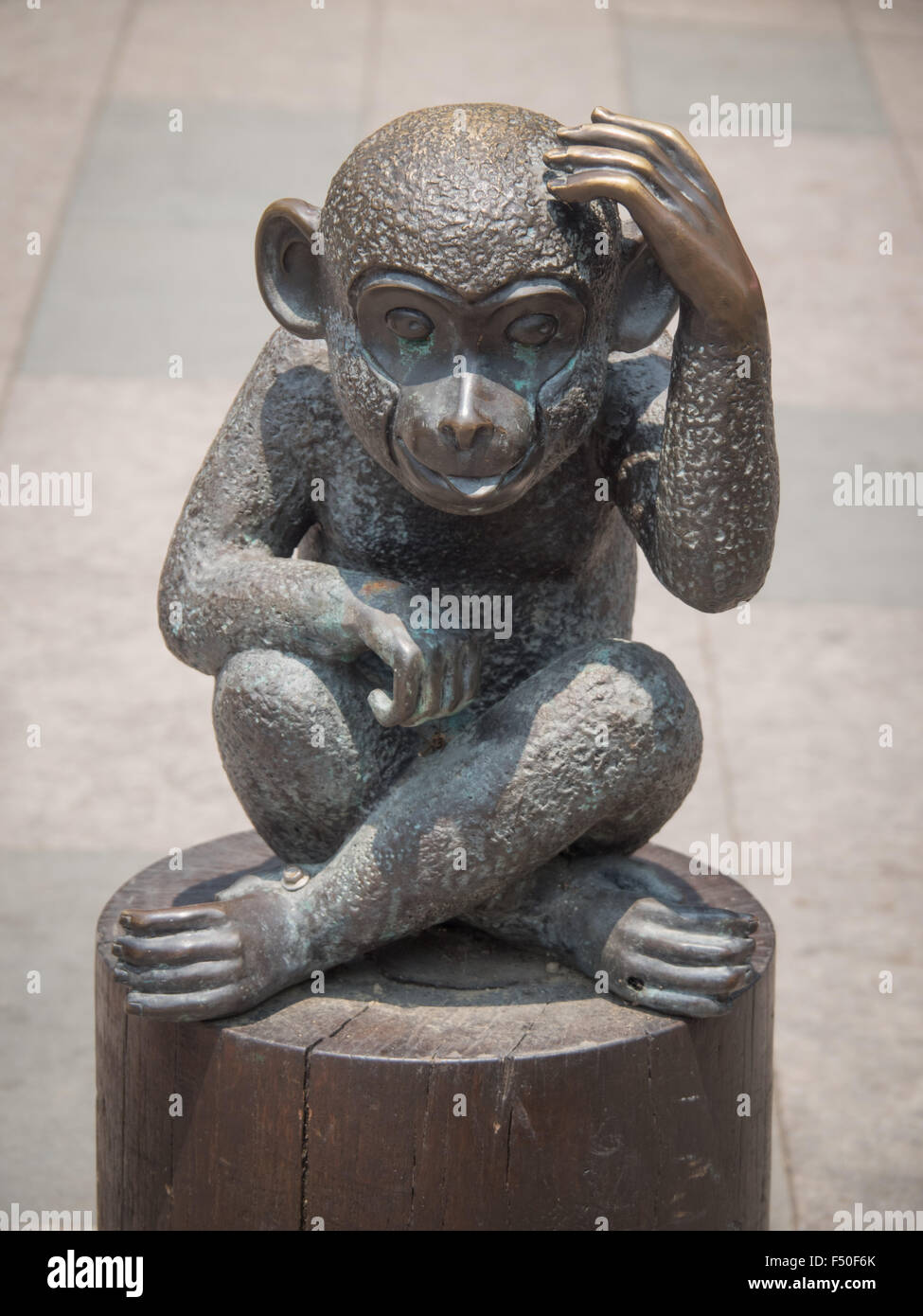 Bronze statue of a monkey scratching head Stock Photo