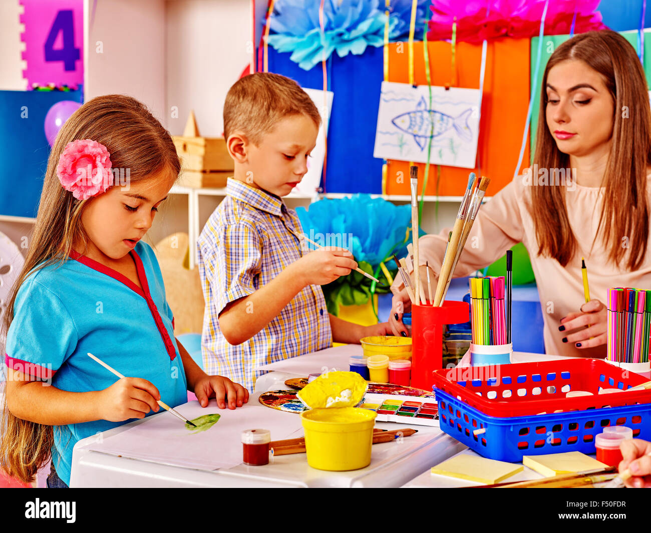 Children with teacher in preschool kindergarten Stock Photo - Alamy