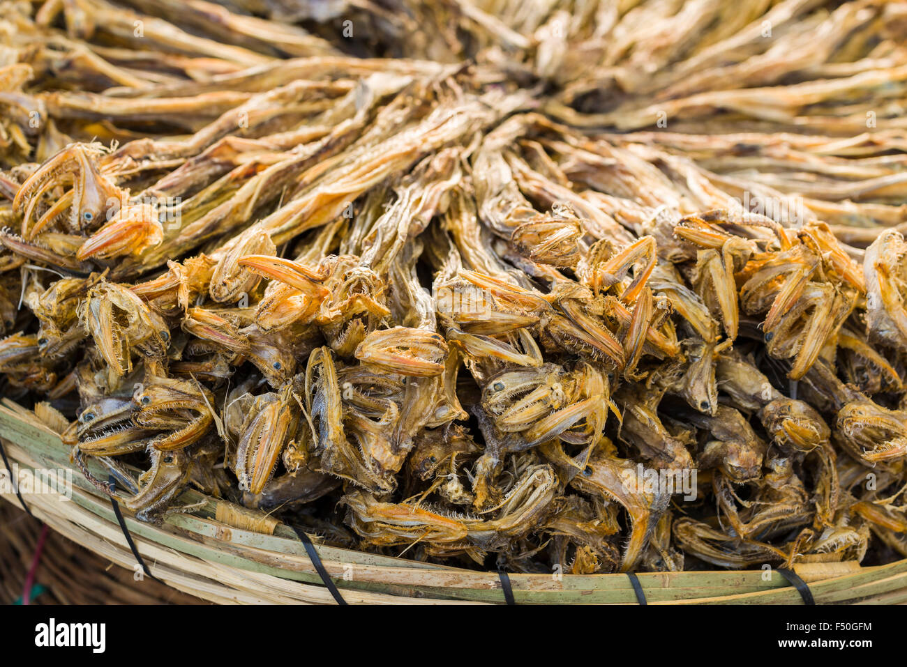 Baskets filled with dried fish are for sale at the weekly vegetable market Stock Photo