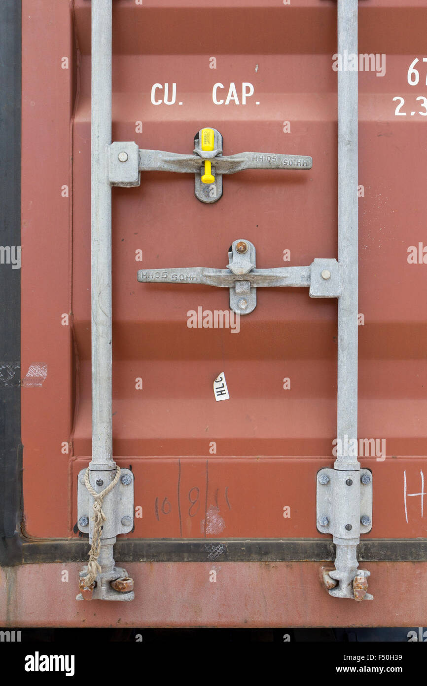 Shipping container locking handles with a uniquely numbered customs seal Stock Photo Alamy