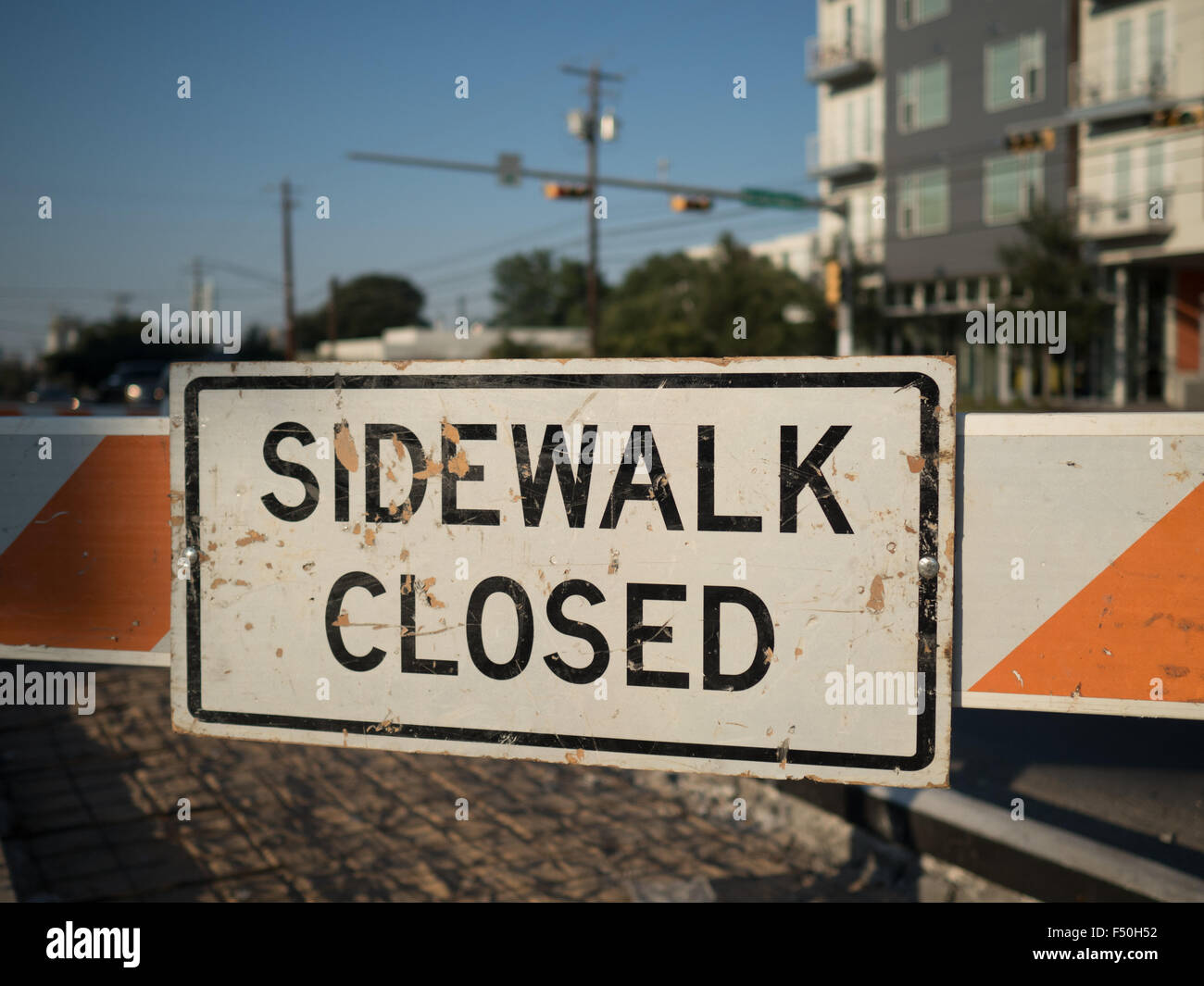 Orange 'sidewalk closed' sign on the streets of Austin, Texas Stock Photo