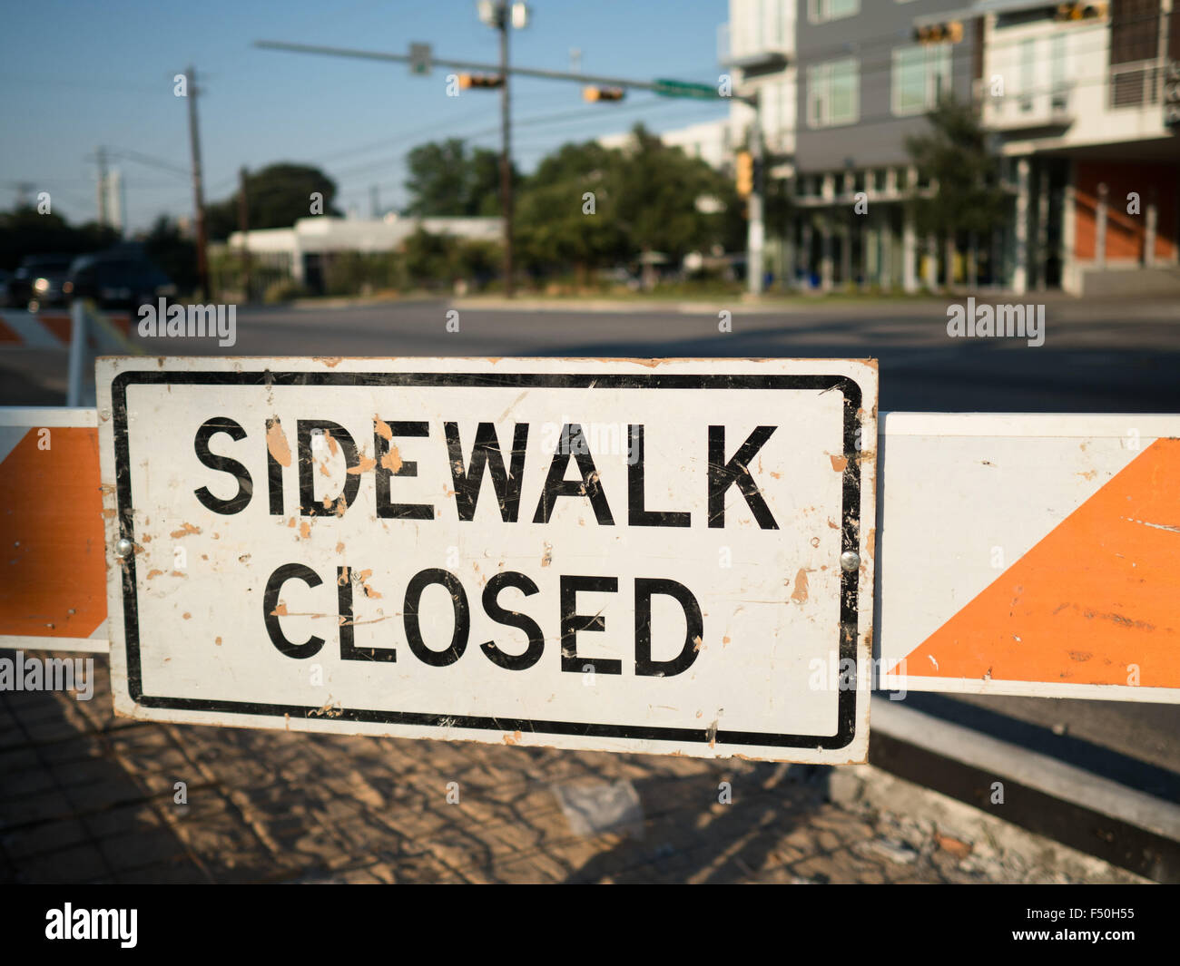 Orange 'sidewalk closed' sign on the streets of Austin, Texas Stock Photo
