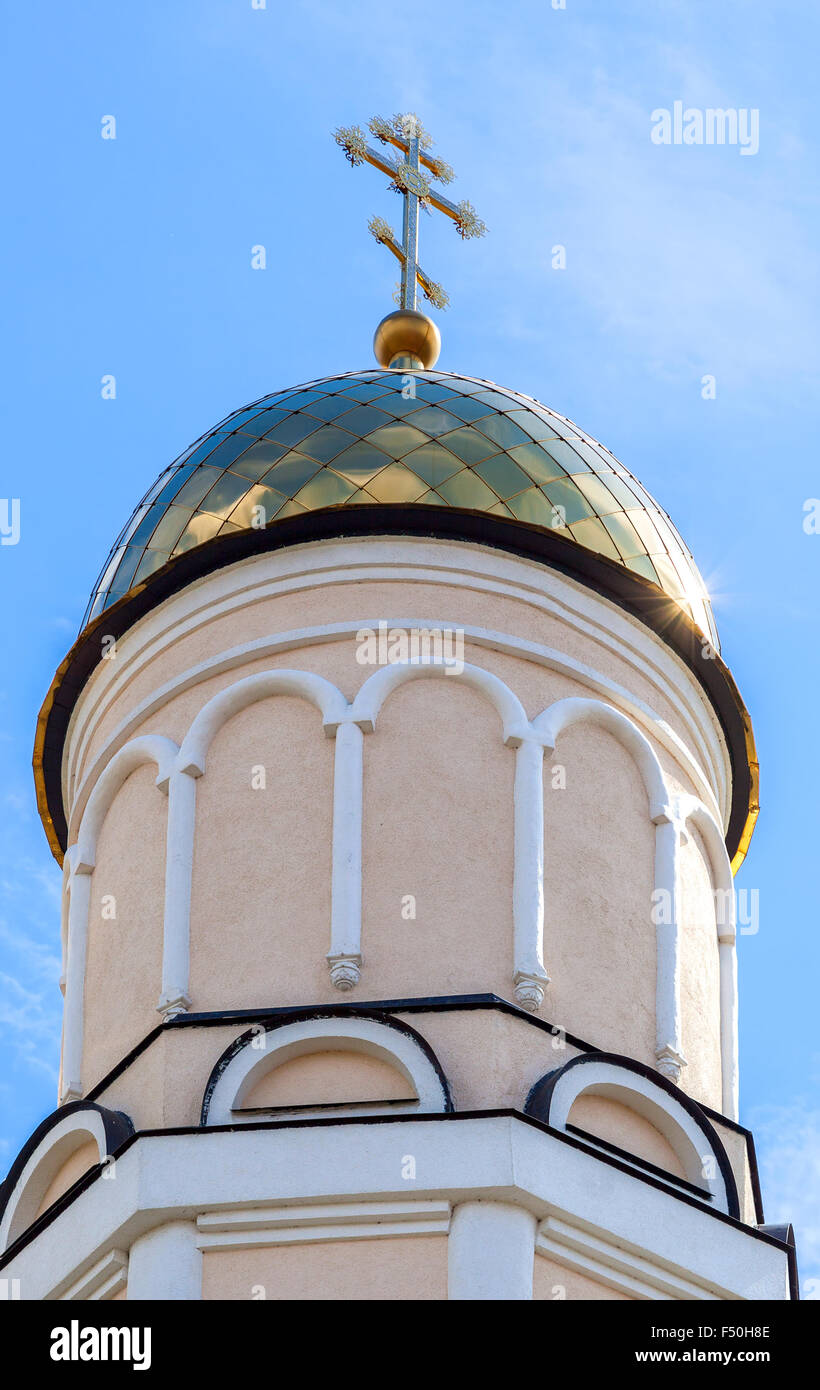 Golden dome of Russian orthodox church with cross against blue sky ...