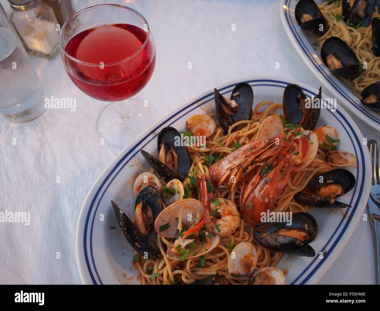 Seafood pasta with clams, mussels, and shrimp in Greece Stock Photo