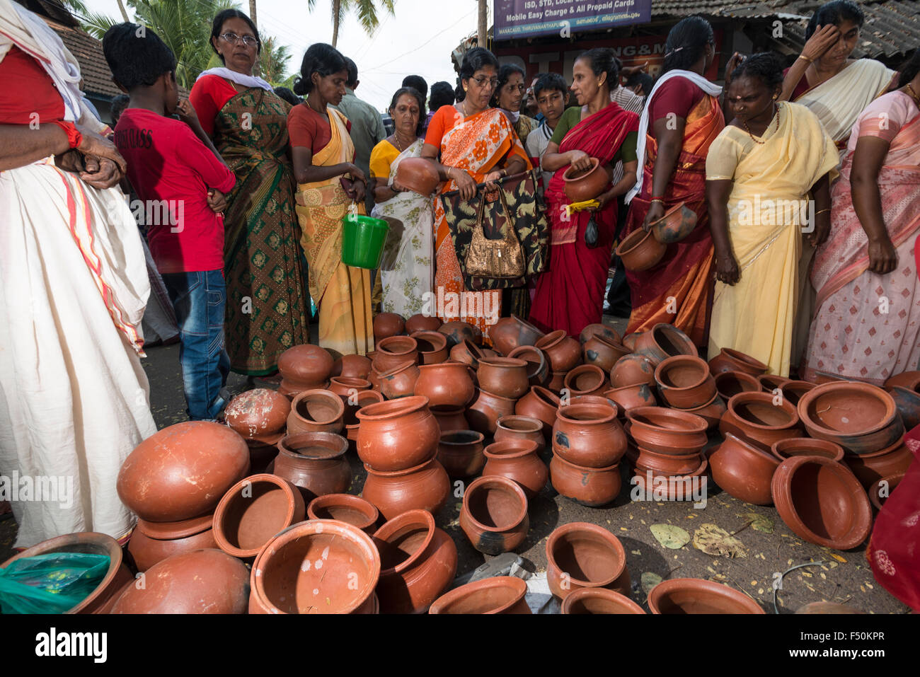 Clay pots for cooking are for sale in a busy street during the Pongala