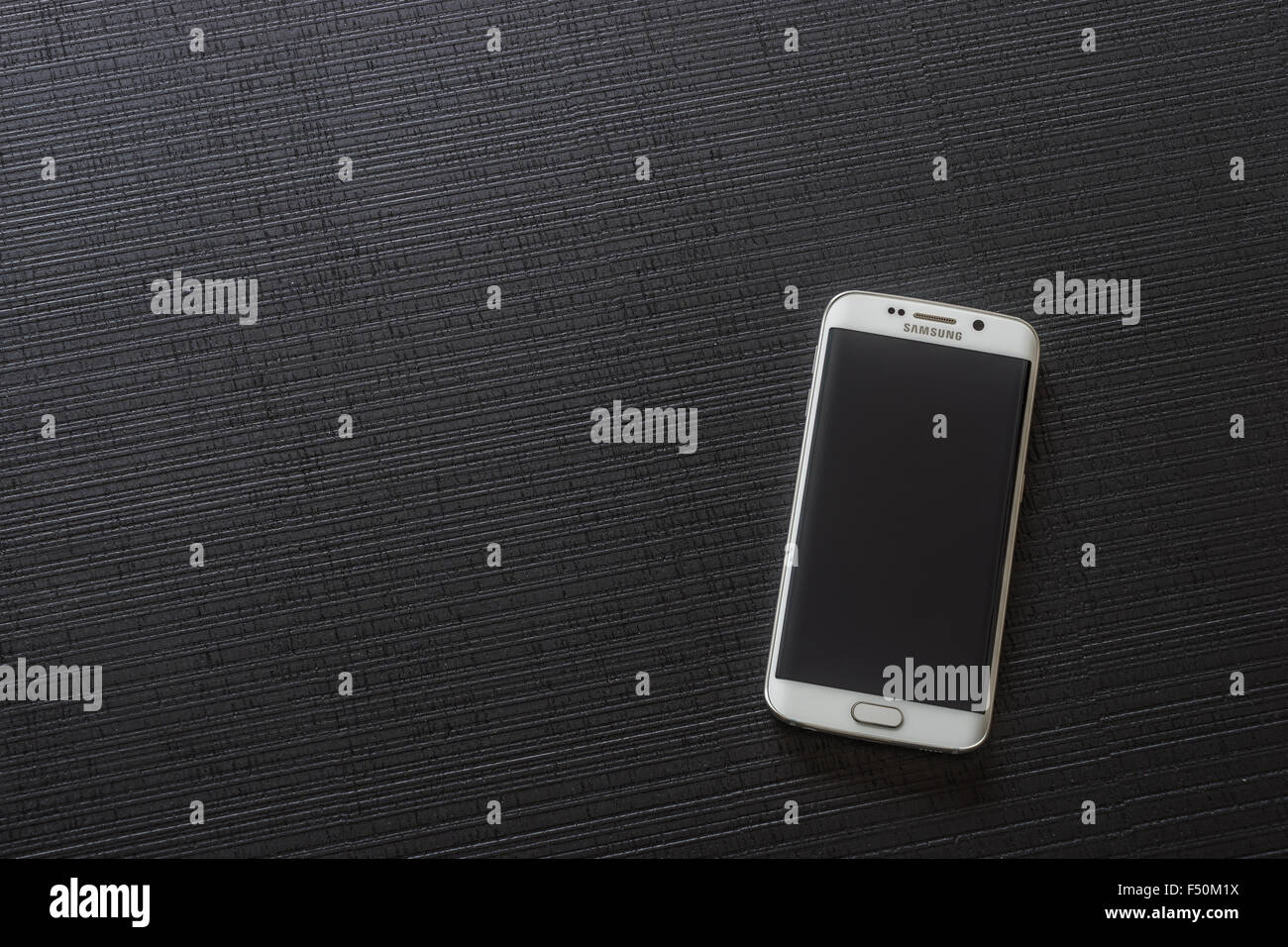 Samsung Galaxy S6 Edge smartphone laying on a table Stock Photo