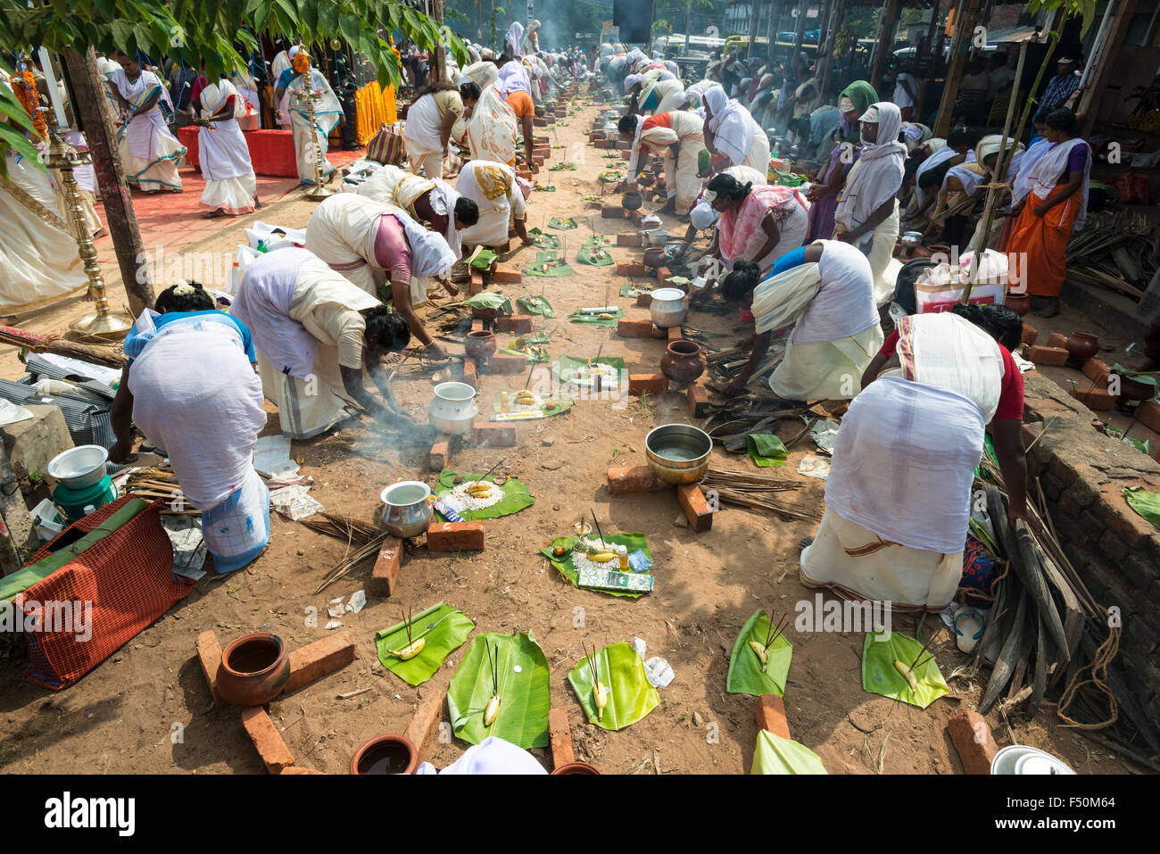 Many women, 3,5 millions in total, are cooking prasad on open fire in the busy streets during the Pongala festival Stock Photo