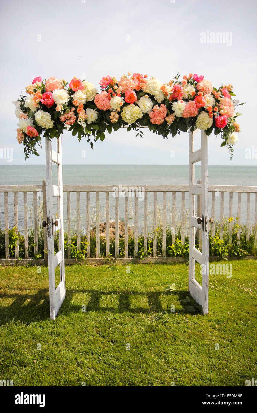 Flowers on a trellis made from doors overlooking the ocean at a wedding ceremony, Pelham House Resort,  East Dennis, Cape Cod Stock Photo