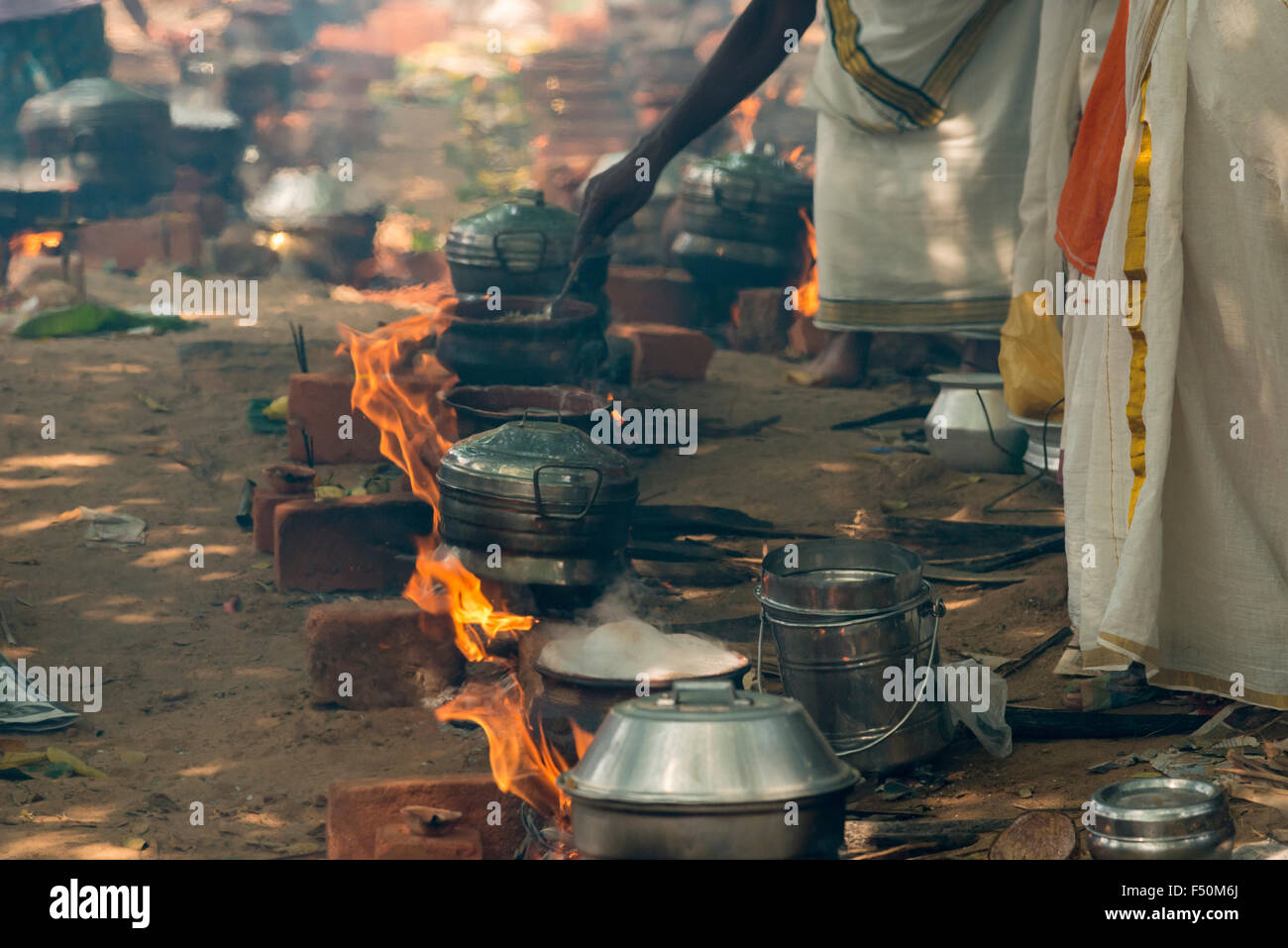 Many women, 3,5 millions in total, are cooking prasad on open fire in the busy streets during the Pongala festival Stock Photo