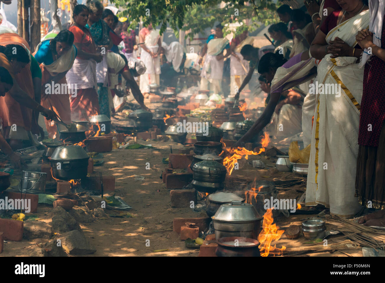 Many women, 3,5 millions in total, are cooking prasad on open fire in the busy streets during the Pongala festival Stock Photo