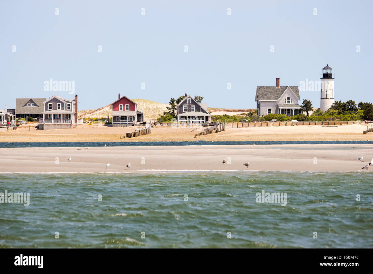 Sandy Neck Beach's old cottage colony and lighthouse seen from the water, Cape Cod, Massachusetts Stock Photo