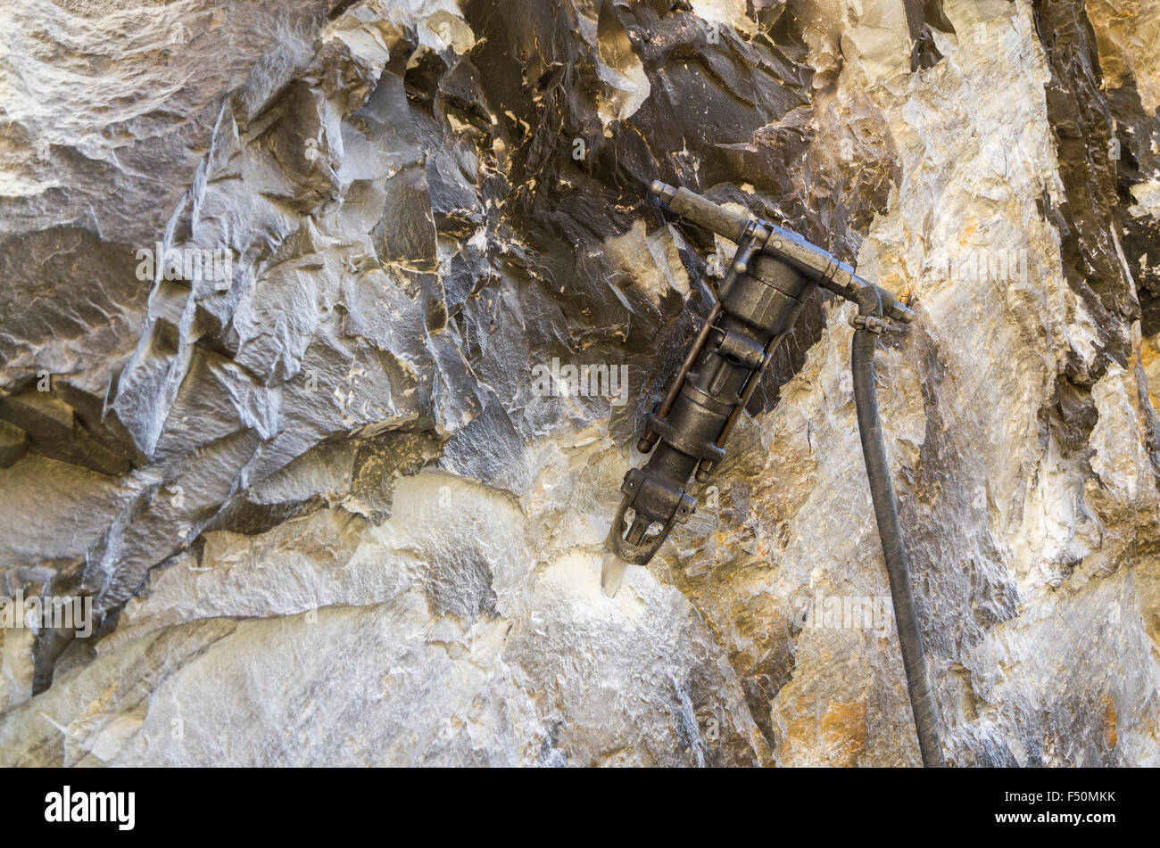 Pneumatic hammer to construct a road, dangerously leading along a steep valley Stock Photo