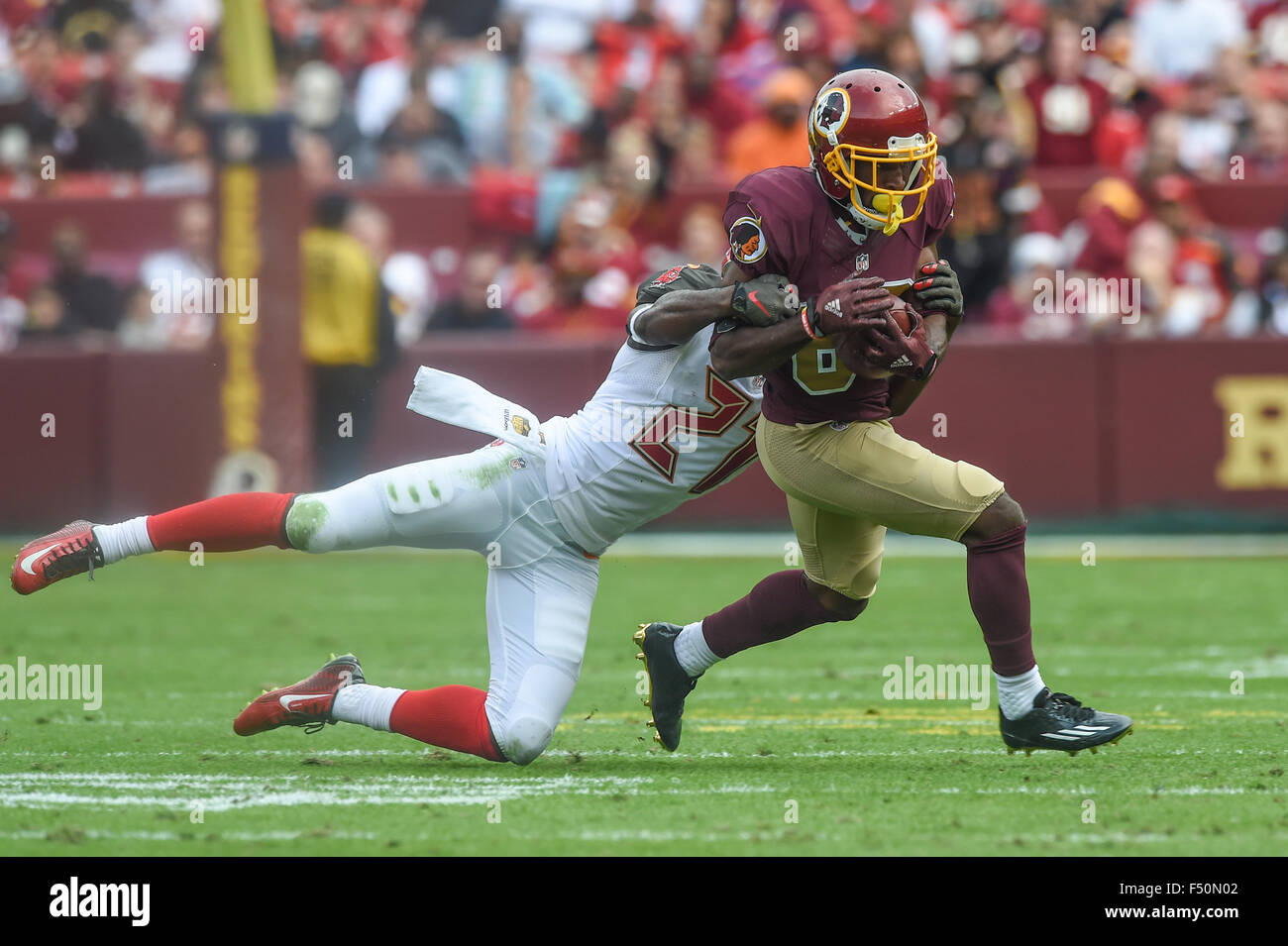 OCT 25, 2015 : Tampa Bay Buccaneers cornerback Alterraun Verner (21) tries to tackle Washington Redskins wide receiver Jamison Crowder (80) during the matchup between the Tampa Bay Buccaneers and the Washington Redskins at FedEx Field in Landover, MD. The Redskins came back from a halftime deficit of 24-7 to defeat the Buccaneers 31-30. Stock Photo