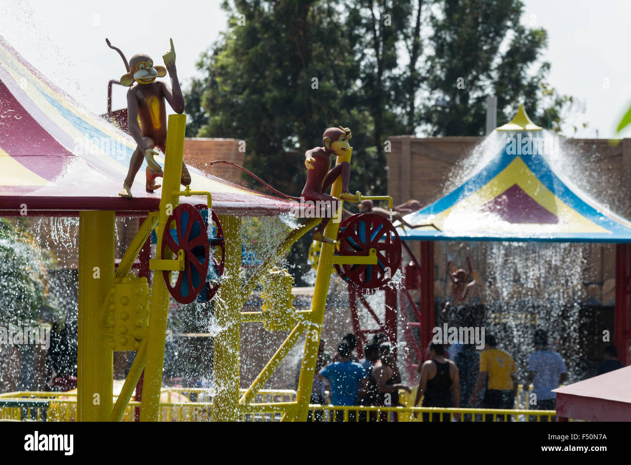 People play in water fountains at Wonder La, the big amusement park outside of Bangalore. The park features a wide variety of at Stock Photo