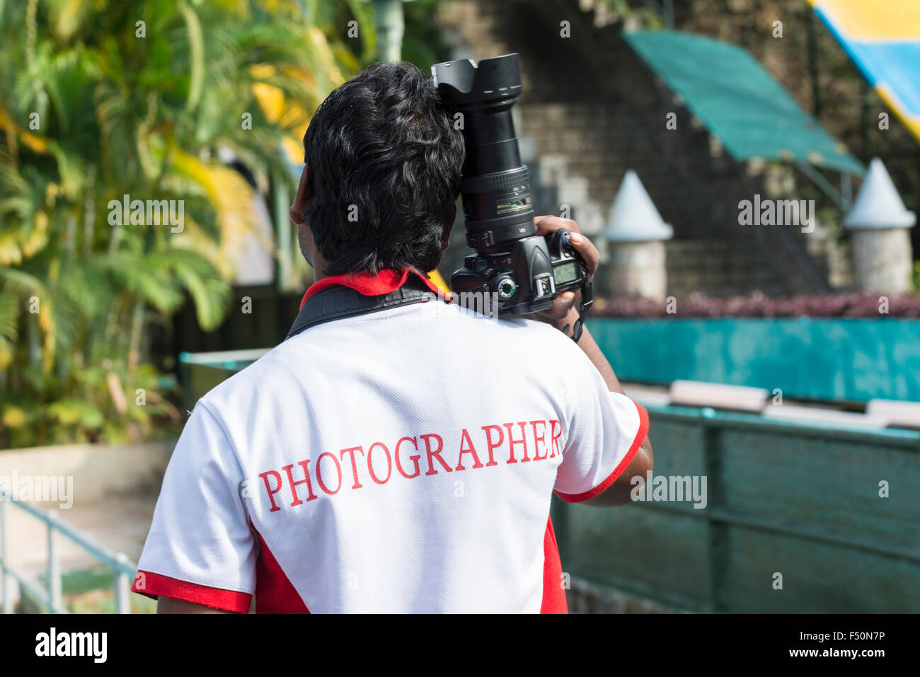 A professional photographer is taking pictures at Wonder La, the big amusement park outside of Bangalore. The park features a wi Stock Photo