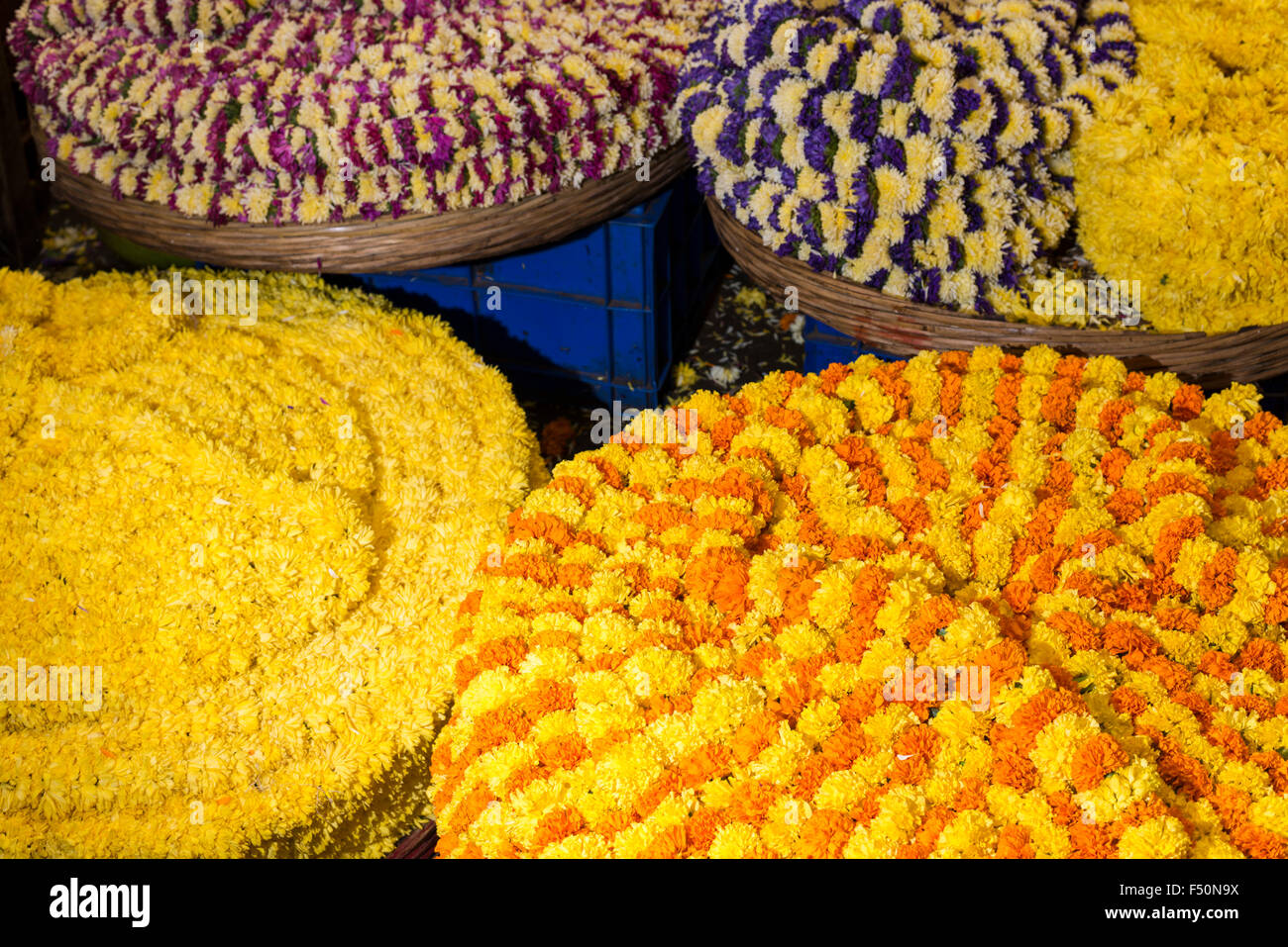 Big baskets full of yellow and orange marigold flowers for devotional