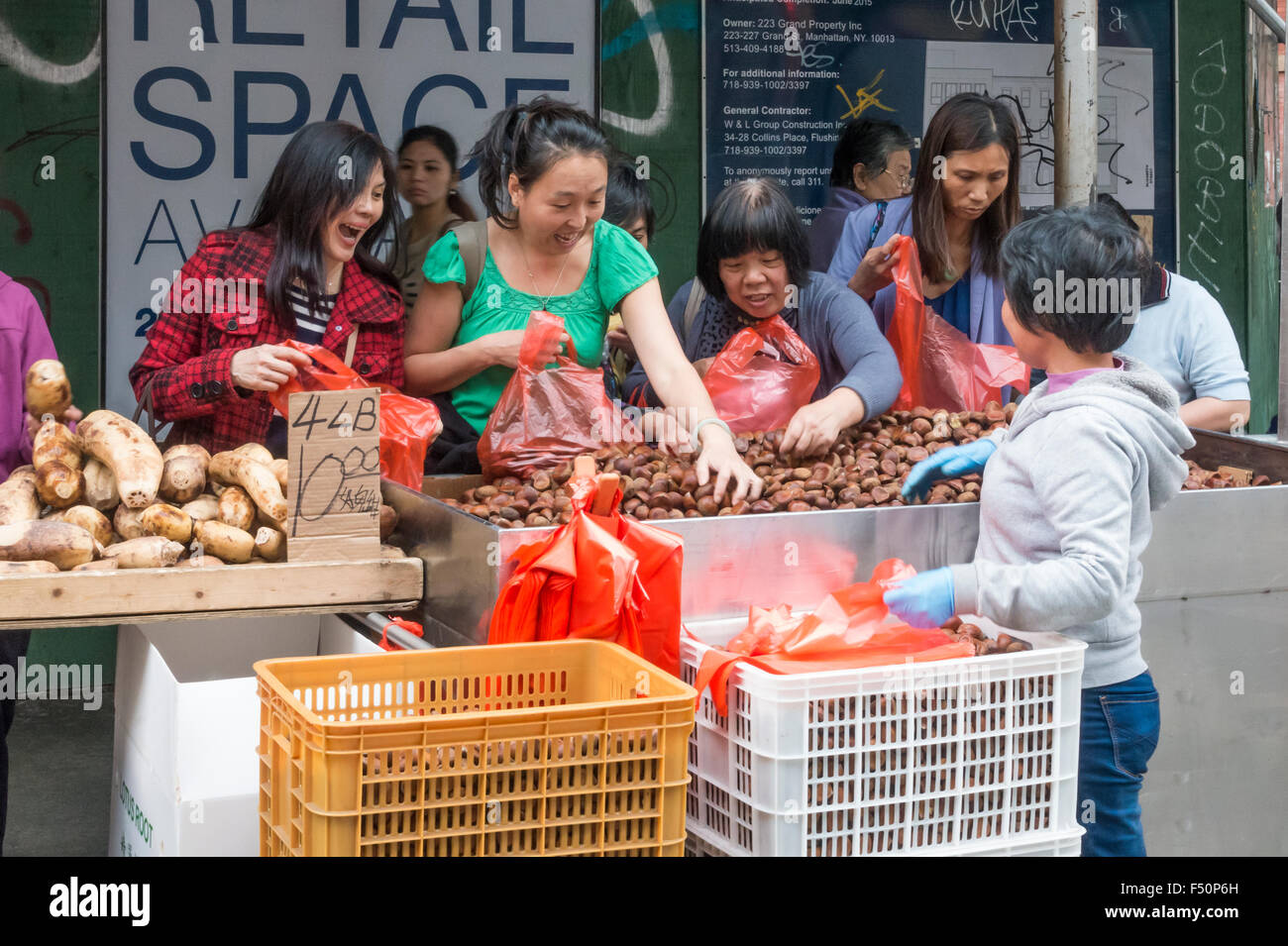 Asian women food shopping on the street in Chinatown in New York City Stock Photo