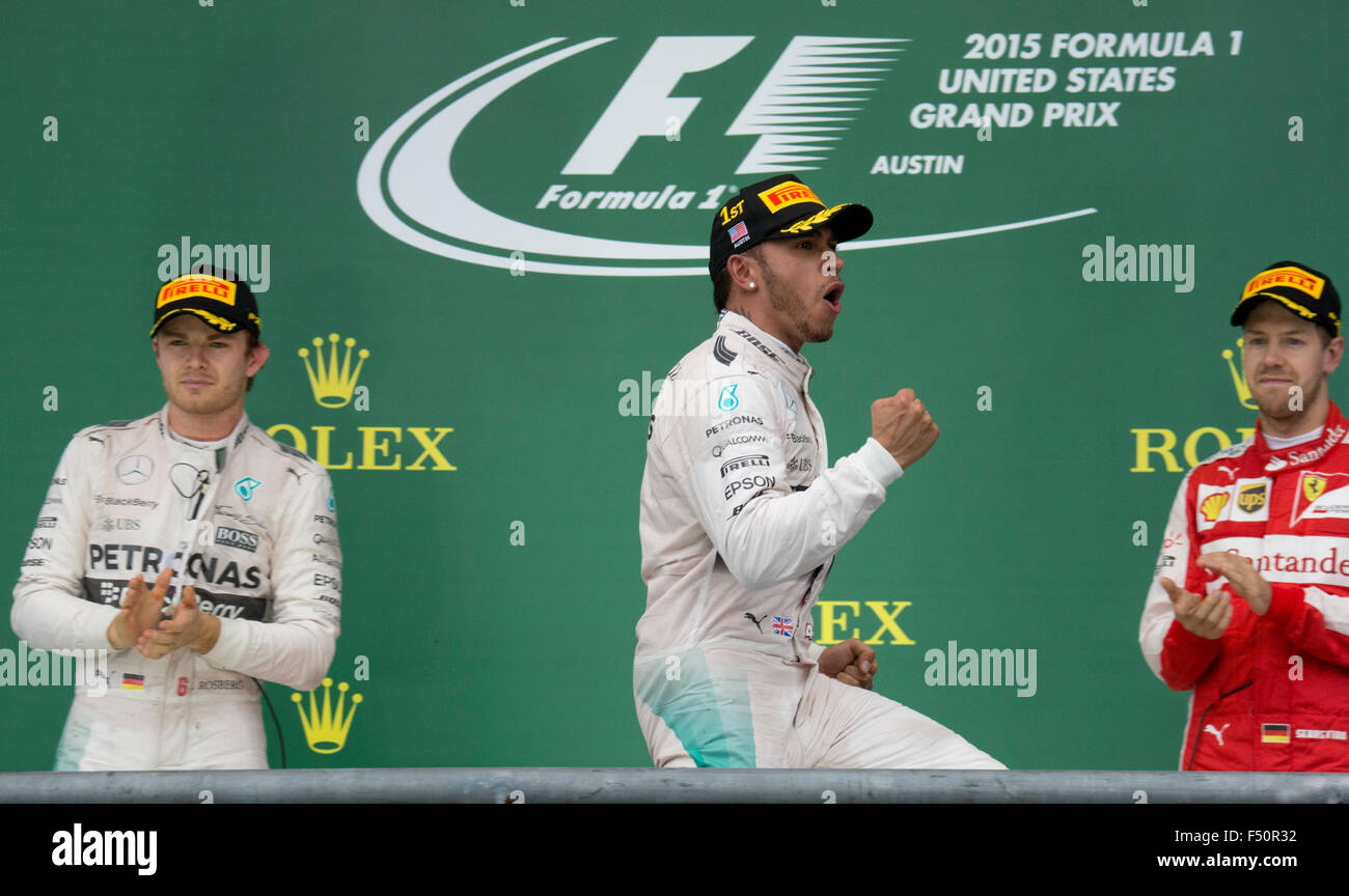 Austin, TX USA October 25, 2015: Formula 1 driver Lewis Hamilton celebrates his victory over teammate Nico Rosberg in the United States Grand Prix that clinched his world championship title. At left is Nico Rosberg in second place and at right is thrid place Sebastian Vettel. Stock Photo