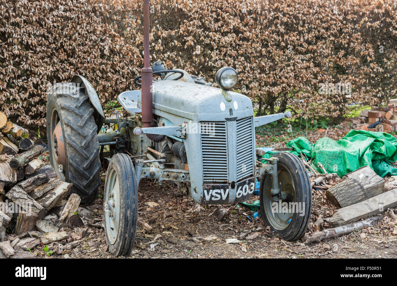 Broken down and dilapidated vintage, grey, old-fashioned traditional design tractor Stock Photo