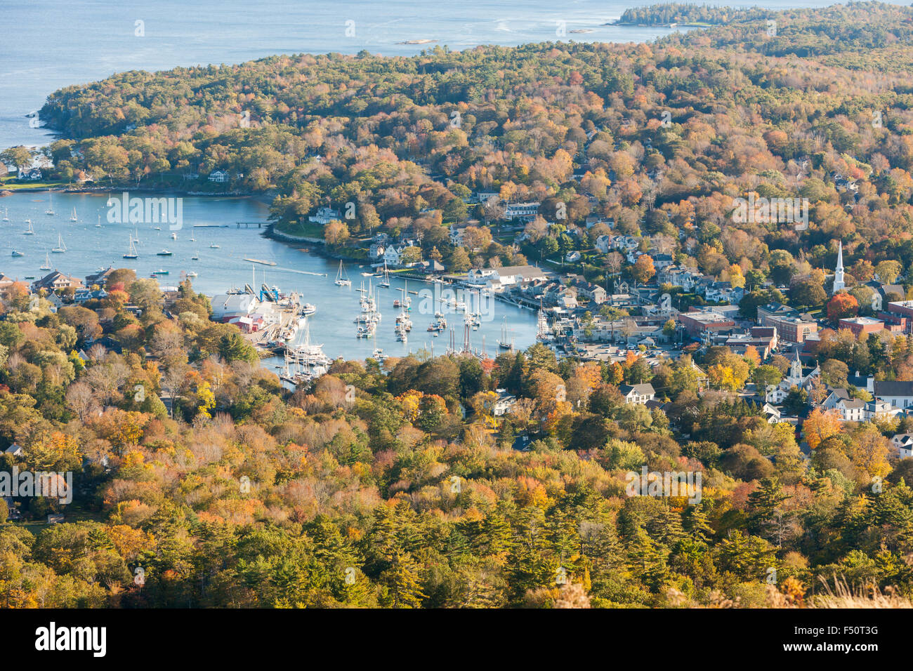 A birds-eye-view of Camden Harbor and surrounding fall foliage from Mt. Battie in Camden, Maine. Stock Photo