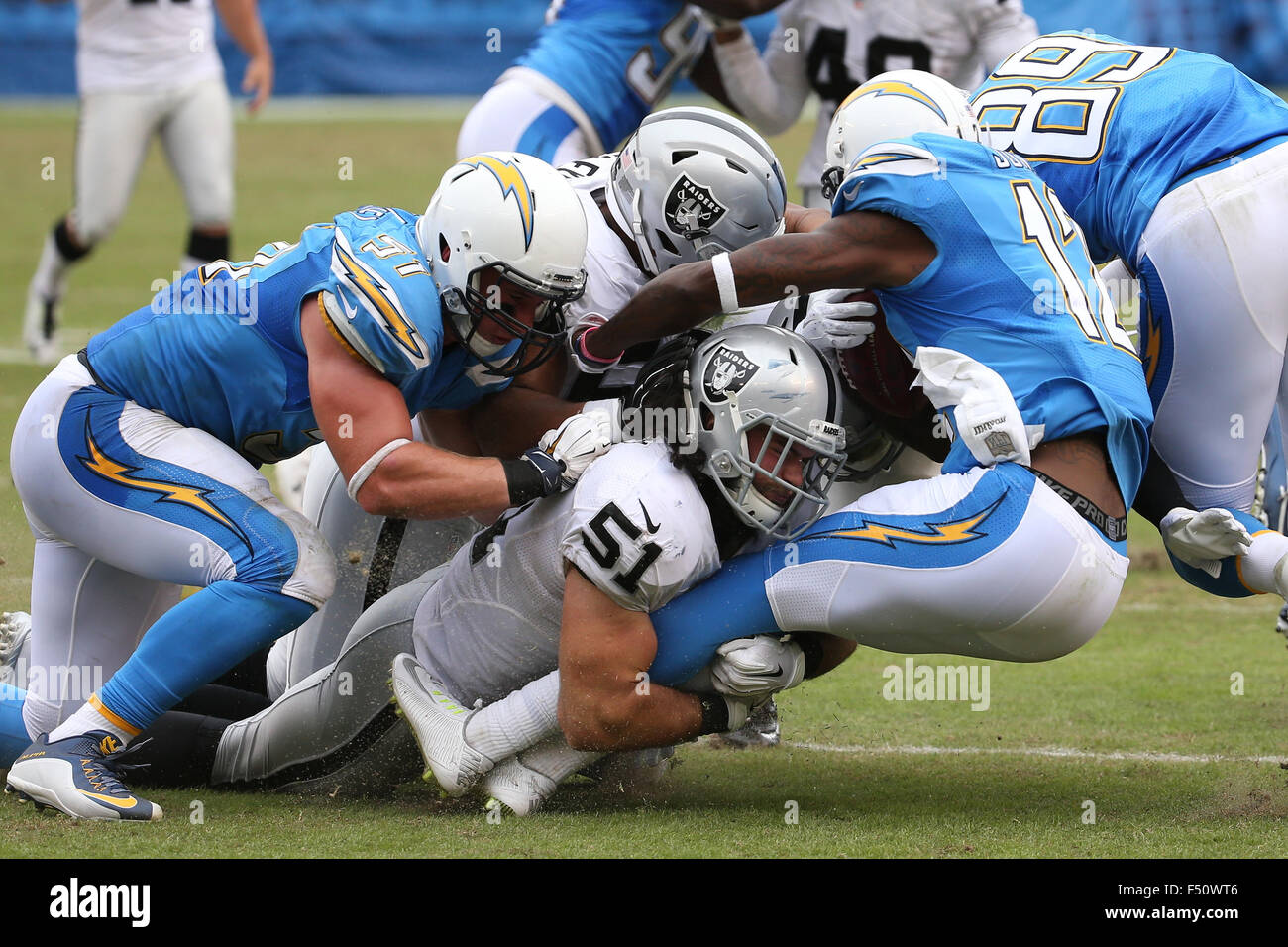 San Diego, CA, USA. 25th Oct, 2015. October 25, 2015: Oakland Raiders inside linebacker Ben Heeney (51) and two teammates makes a hard hit on San Diego Chargers wide receiver Jacoby Jones (12) in the game between the Oakland Raiders and San Diego Chargers, Qualcomm Stadium, San Diego, CA. Photographer: Peter Joneleit/ ZUMA Wire Service Credit:  Peter Joneleit/ZUMA Wire/Alamy Live News Stock Photo