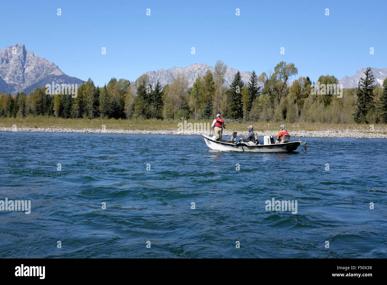 Fishing on the Snake River with the Grand Tetons in the background Stock Photo