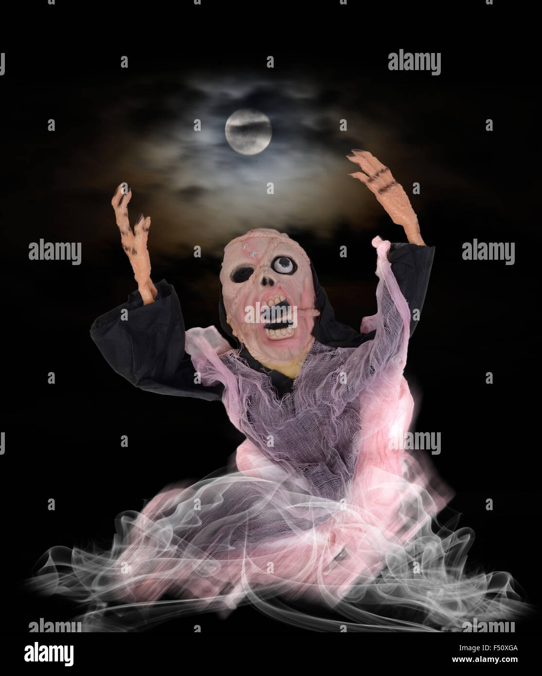 Screaming ghost looking to full moon in halloween night. Stock Photo
