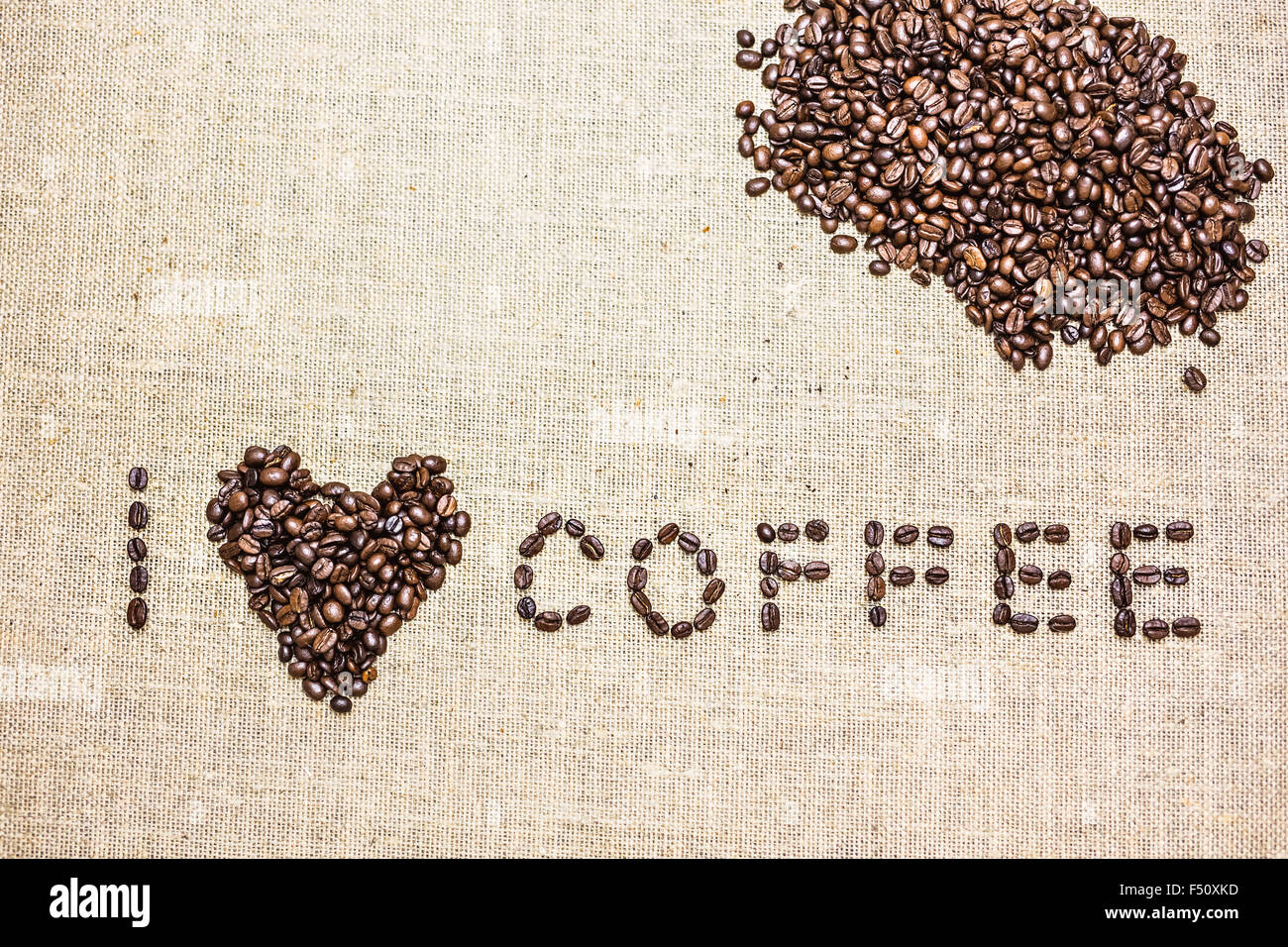 coffee beans and mug used to spell love on hessian sack Stock Photo - Alamy