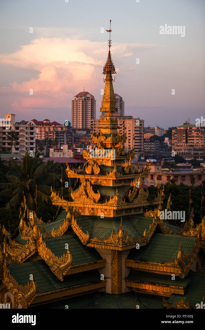 A view of a roof of a temple next to the Shwedagon Pagoda during sunset. Stock Photo