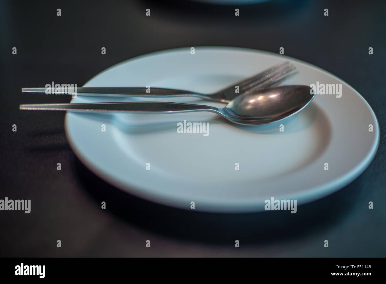 Empty dinner plate on the table in the restaurant, wait Stock Photo