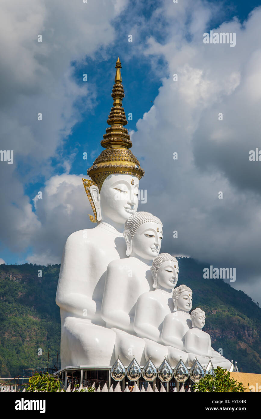 White Buddha statue amidst the mountains in Thailand, wat phasornkaew