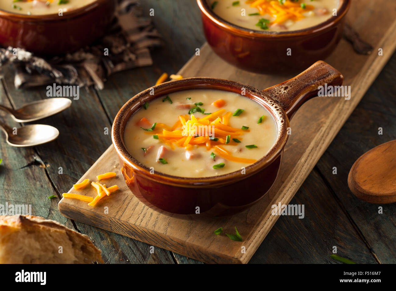 Homemade Beer Cheese Soup with Chives and Bread Stock Photo