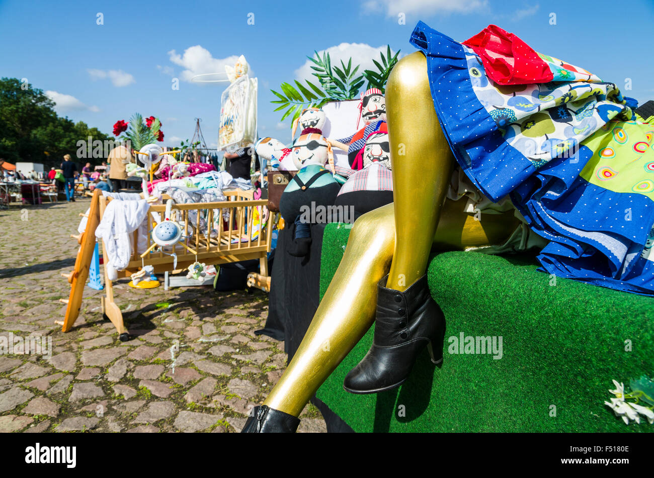 Big puppets are offered for sale at the weekly flea market aside the river Elbe Stock Photo