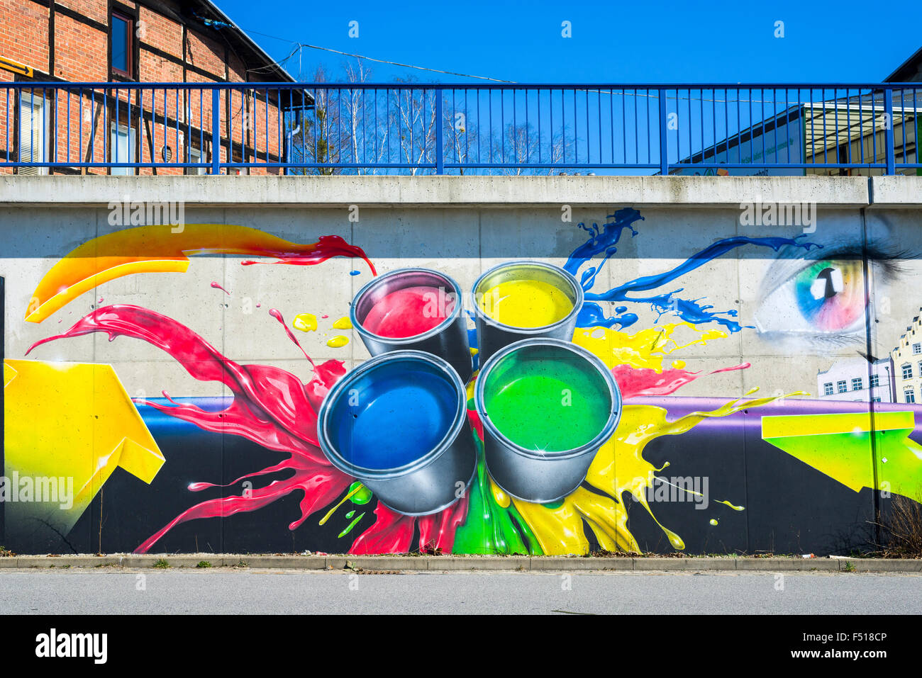 Colorful graffity showing color cans is sprayed on a wall Stock Photo